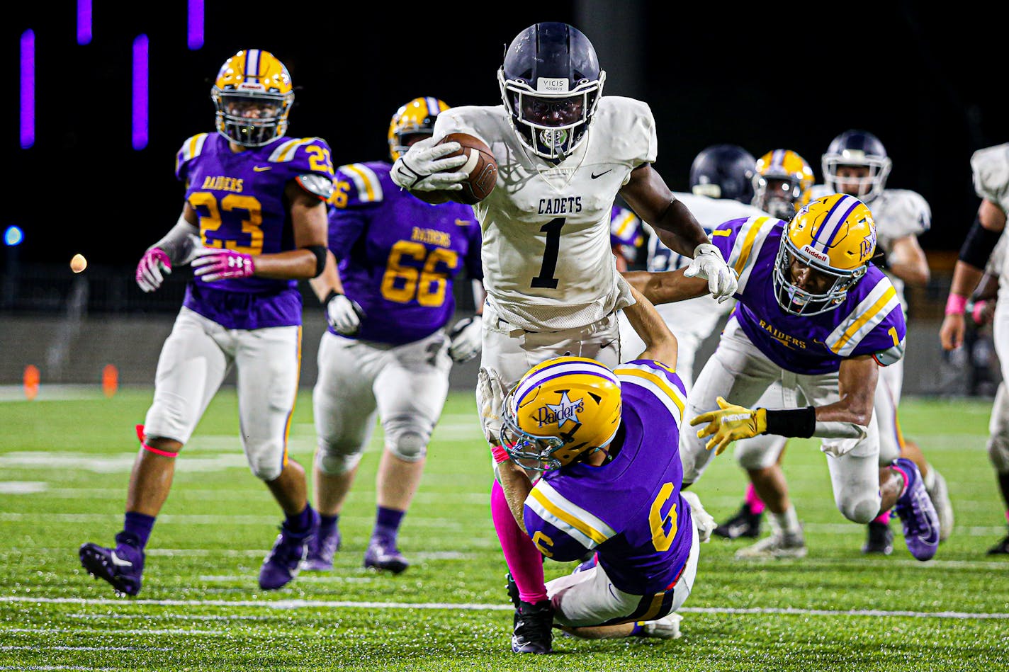 St. Thomas Academy's Love Adebayo ran over Cretin-Derham Hall defender Josh Taylor on his way to a fourth-quarter TD.