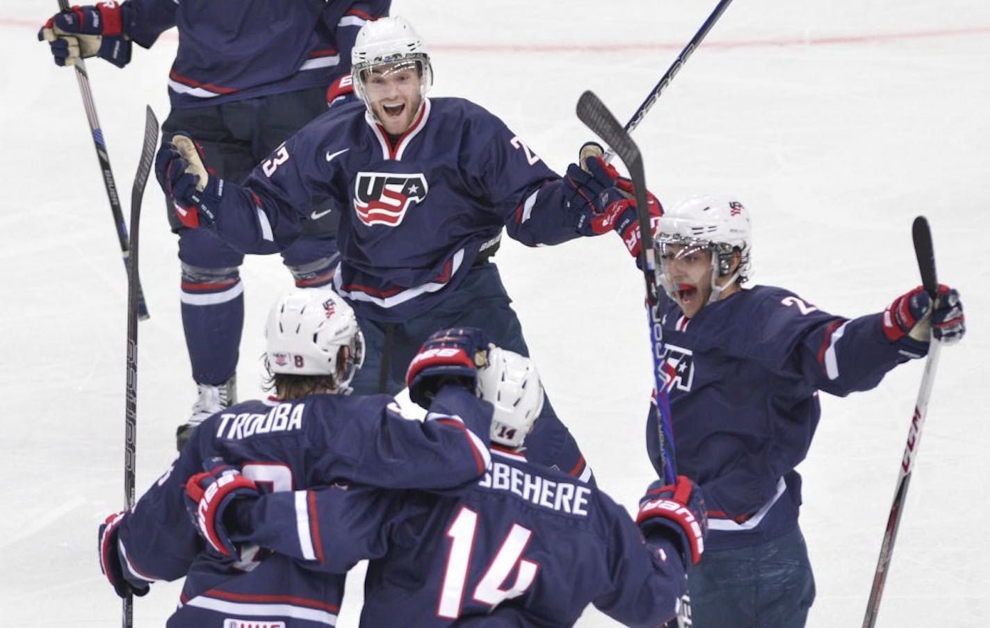 Team USA's Rocco Grimaldi, top celebrates his second goal against Sweden with teammates, from left, Jacob Trouba, Shayne Gostisbehere and Vince Trocheck.