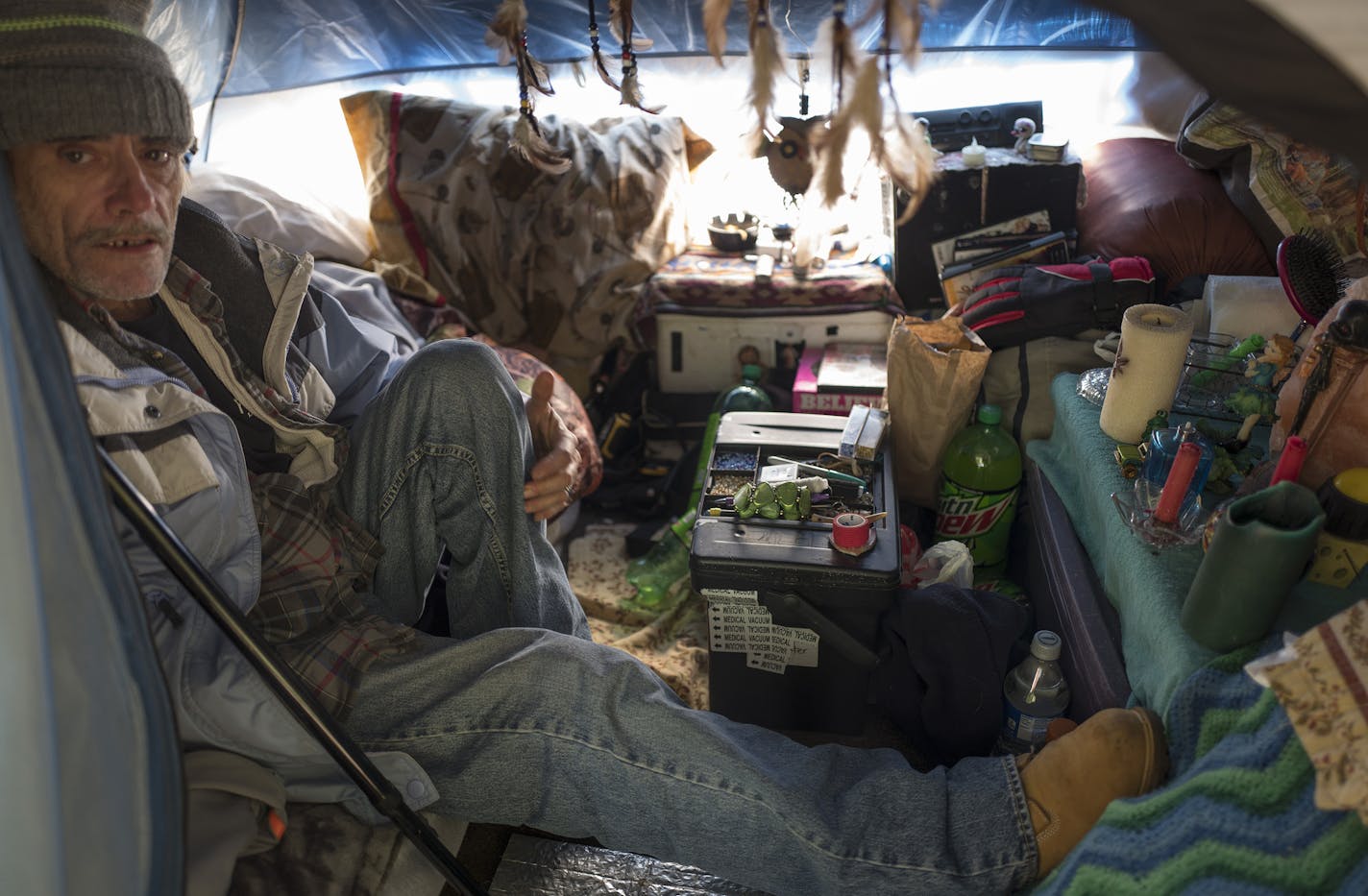 Ernie McGuire, 58, sat in his tent at a homeless encampment near I-35E this week. A caseworker has helped him find a room starting in November.