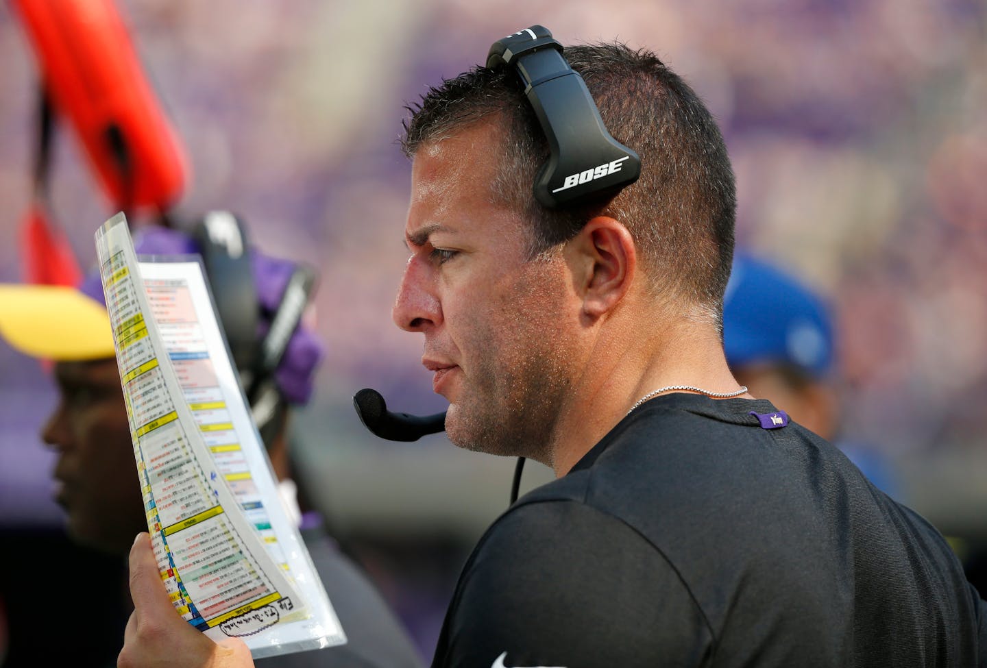 Minnesota Vikings offensive coordinator John DeFilippo looks at his play sheet during the second half of an NFL football game against the Buffalo Bills, Sunday, Sept. 23, 2018, in Minneapolis. The Bills won 27-6. (AP Photo/Bruce Kluckhohn)