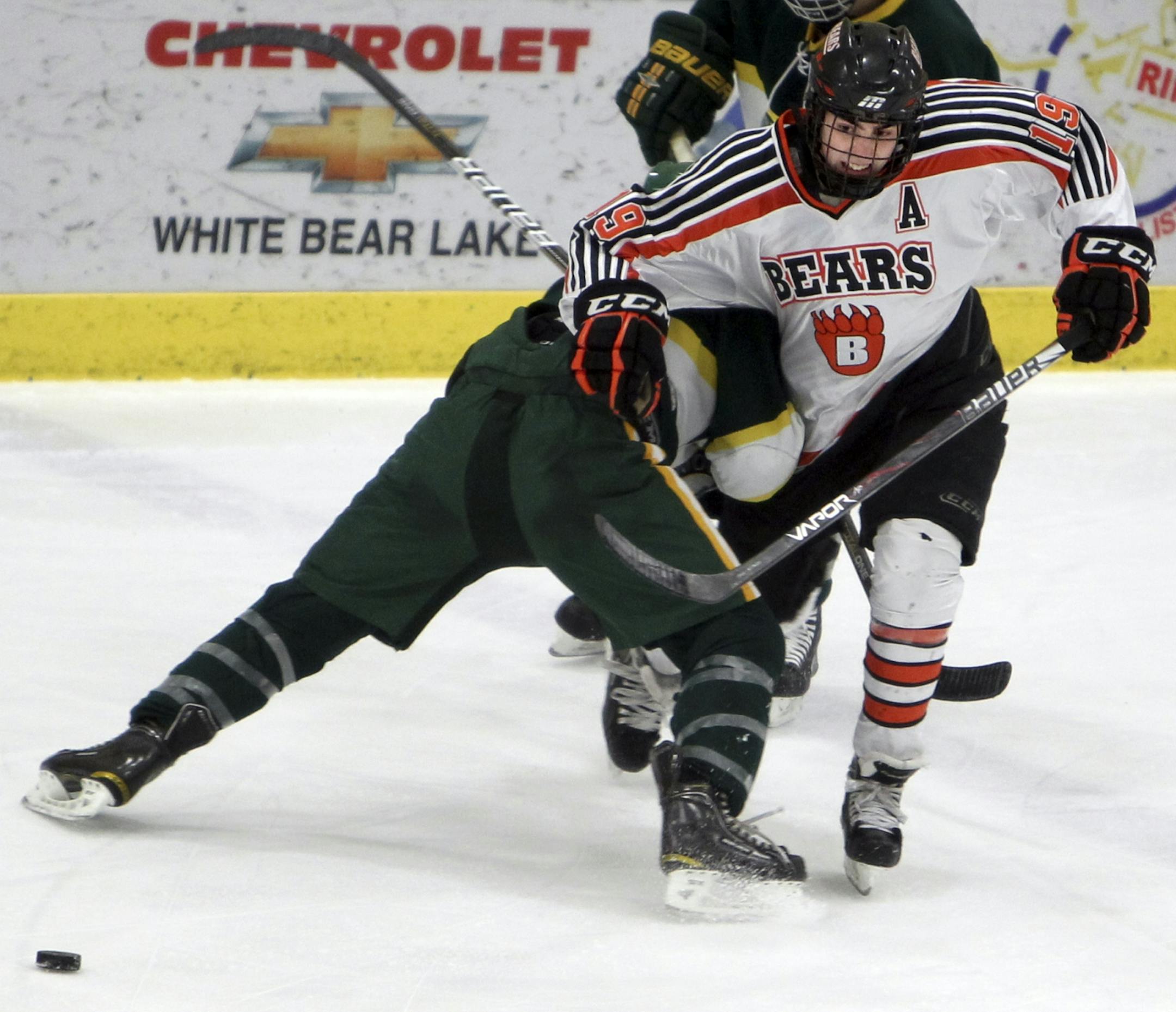 Mitch Morrisette (19) of White Bear Lake High School fights to control the puck as the Bears play Mounds View in boys' varsity hockey at Vadnais Heights Sports Complex in Vadnais Heights February 14, 2012. The Bears won 7-1.