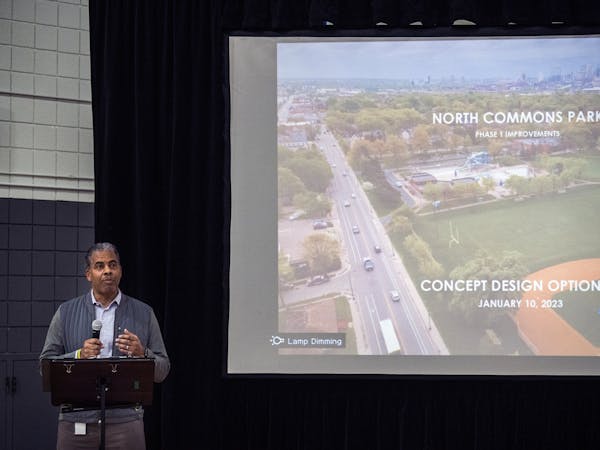 Minneapolis Parks and Recreation Board Superintendent Al Bangoura chats with community members about North Commons Park renovation plans in Minneapoli