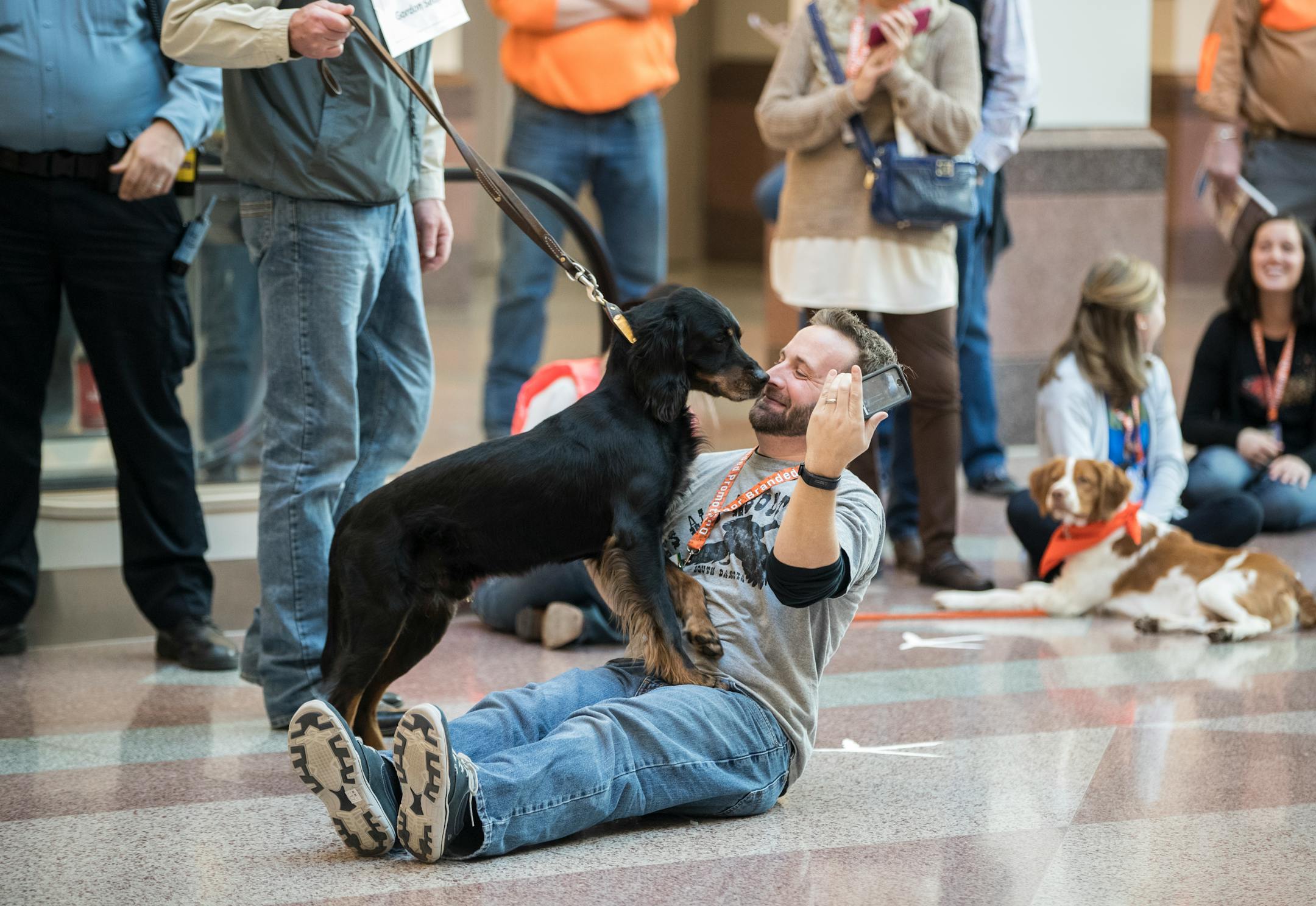 Austin Kaus got a surprise kiss from a dog as he did a live stream for South Dakota Tourism of the "Dog Parade'' that kicked off the Pheasant Fest and Quail Classic at the Minneapolis Convention Center