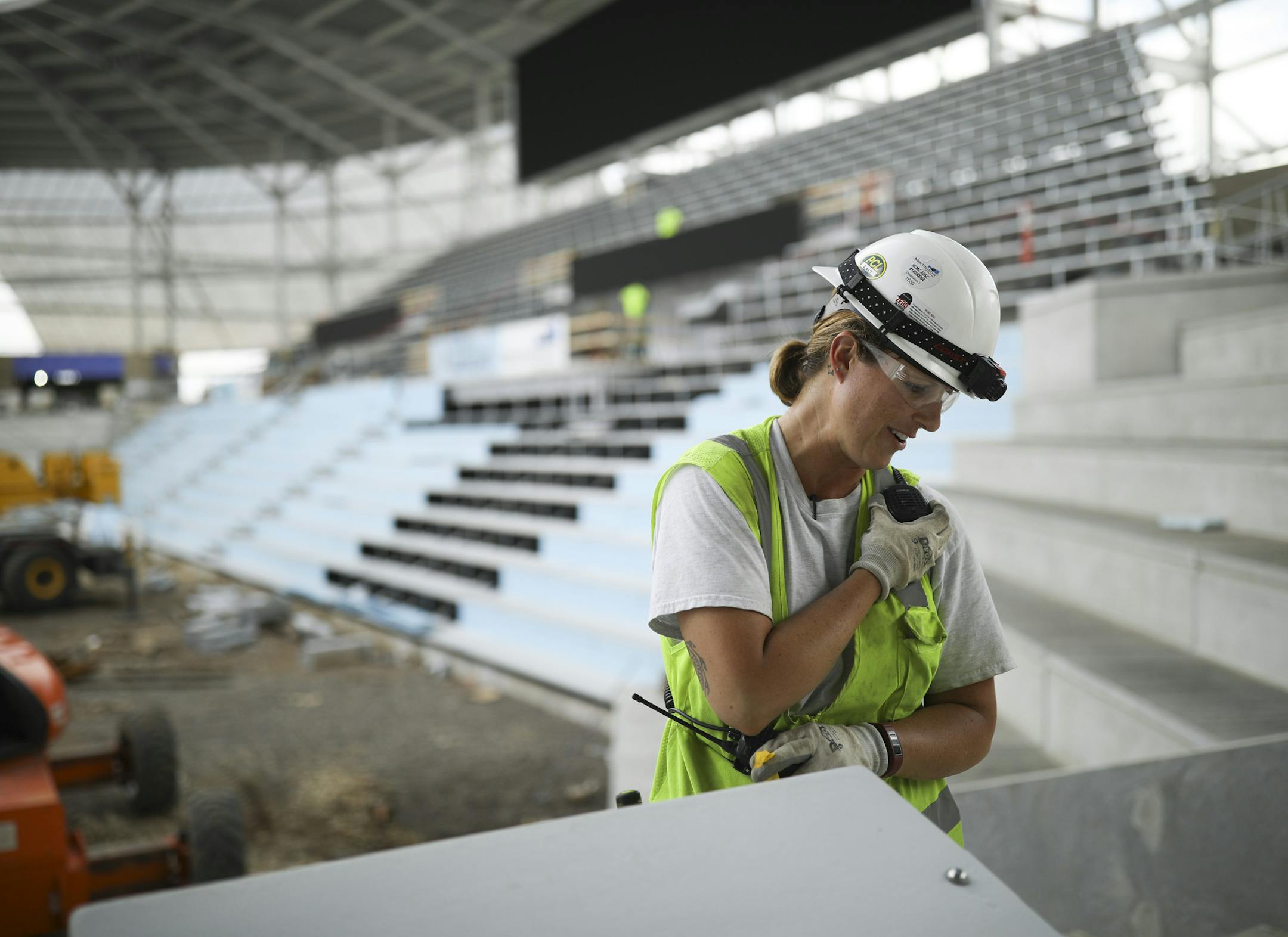 Vanessa Sanders, spoke with a coworker by radio after readying a pair of huge speakers to be hung from the roof of Allianz Field. She's an apprentice electrician working with low voltage installations for Parsons Electric. ] JEFF WHEELER • jeff.wheeler@startribune.com M.A. Mortenson Co. and other construction companies' efforts to increase gender and ethnic diversity in the workplace in the wake of the #metoo and other movements. Workers at the Allianz Stadium work site were photographed