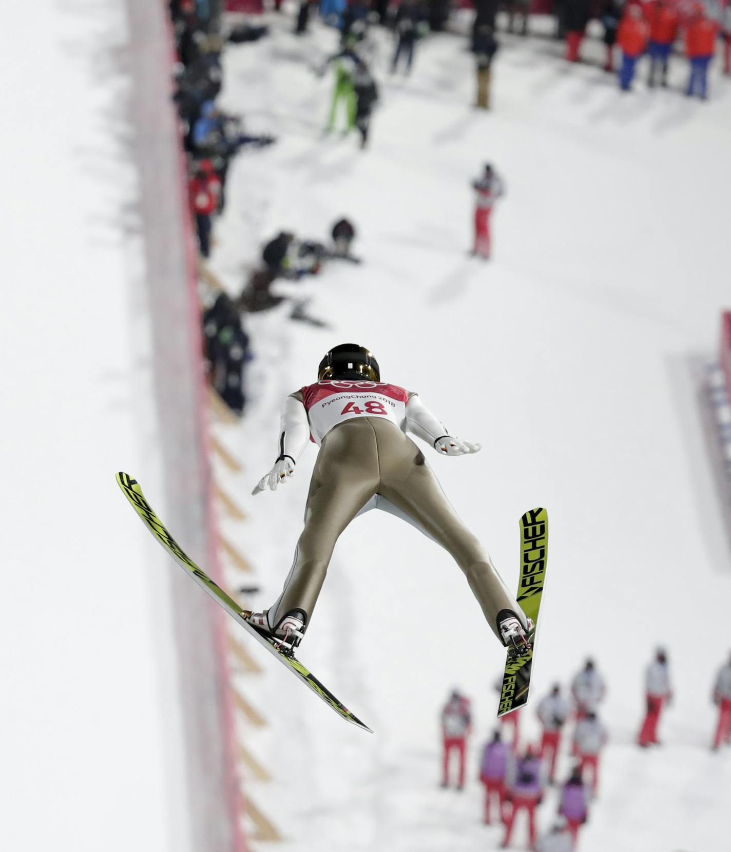 Andreas Wellinger, of Germany, soars through the air during the men's normal hill individual ski jumping competition at the 2018 Winter Olympics in Pyeongchang, South Korea, Sunday, Feb. 11, 2018. (AP Photo/Dmitri Lovetsky)