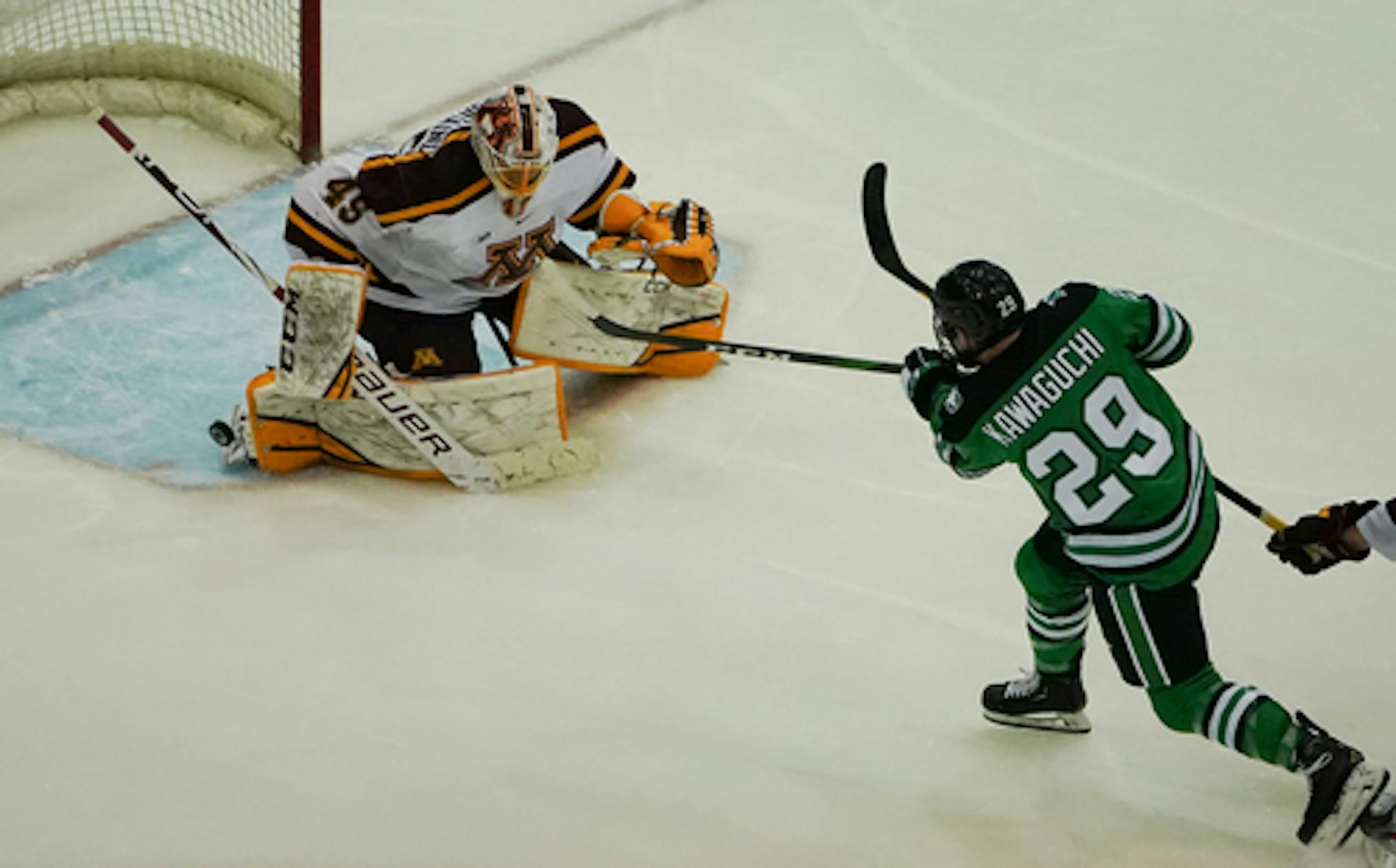 North Dakota forward Jordan Kawaguchi (29) got a shot past the right toe of Minnesota goaltender Jack LaFontaine (45) for a goal in the second period.