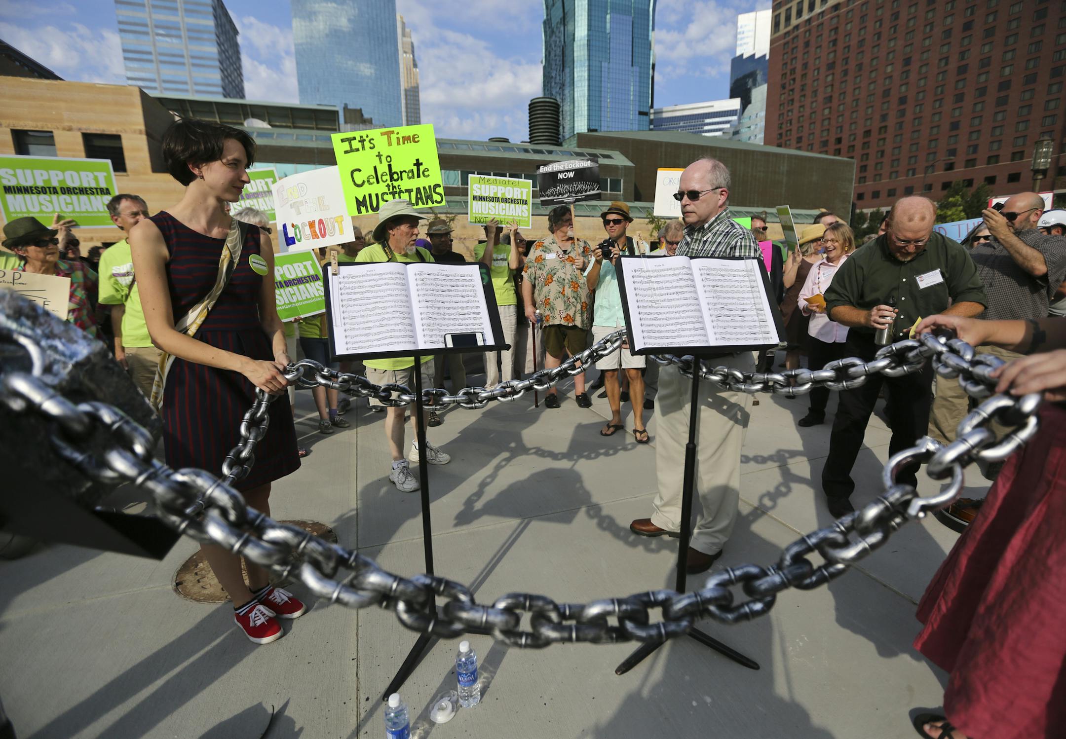 A group of people chained up two music stands and ceremoniously locked them up during a rally in support of Minnesota Orchestra musicians who have been locked out for nearly a year, in Minneapolis, Minn., on Friday, September 6, 2013. ] (RENEE JONES SCHNEIDER • reneejones@startribune.com)