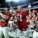 Benilde-St. Margaret's offensive lineman John Whitmore (51) and teammates celebrated their team's 4A championship victory over Winona Friday night.