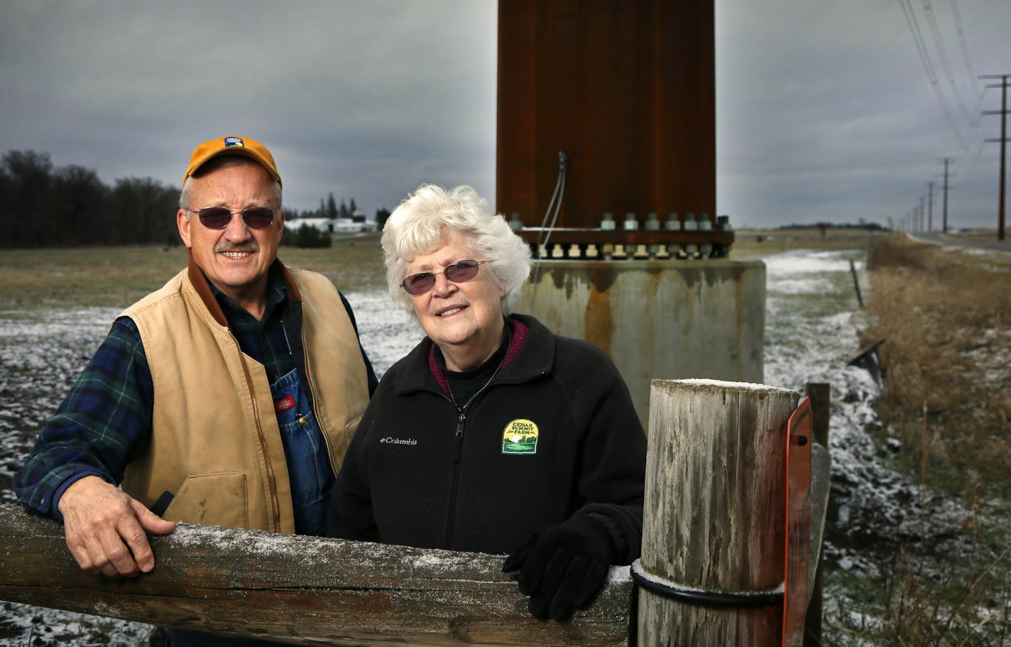 Dave and Florence Minar stand near one of the power poles on their property in New Prague.