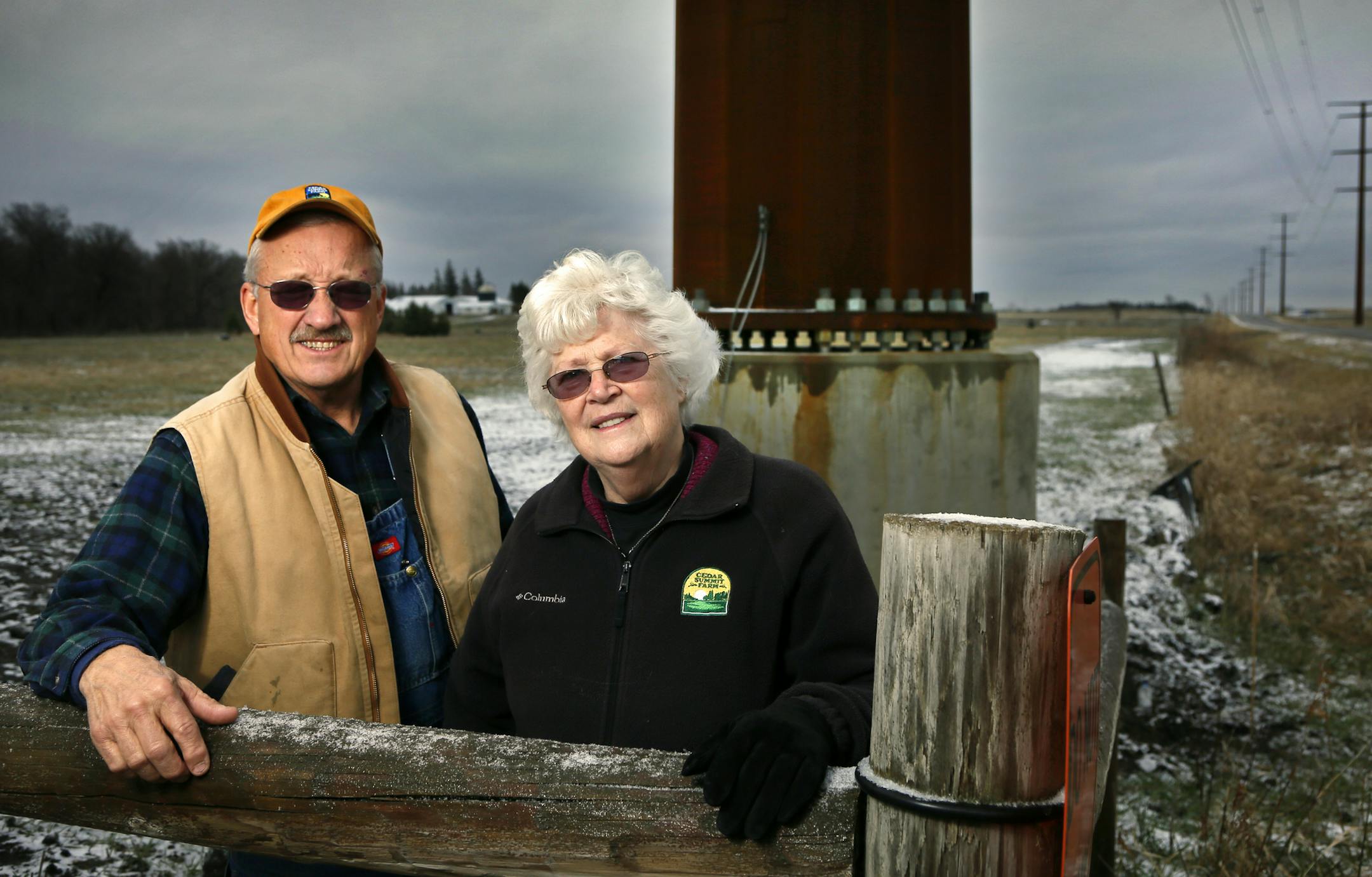 Dave and Florence Minar stand near one of the power poles on their property in New Prague.