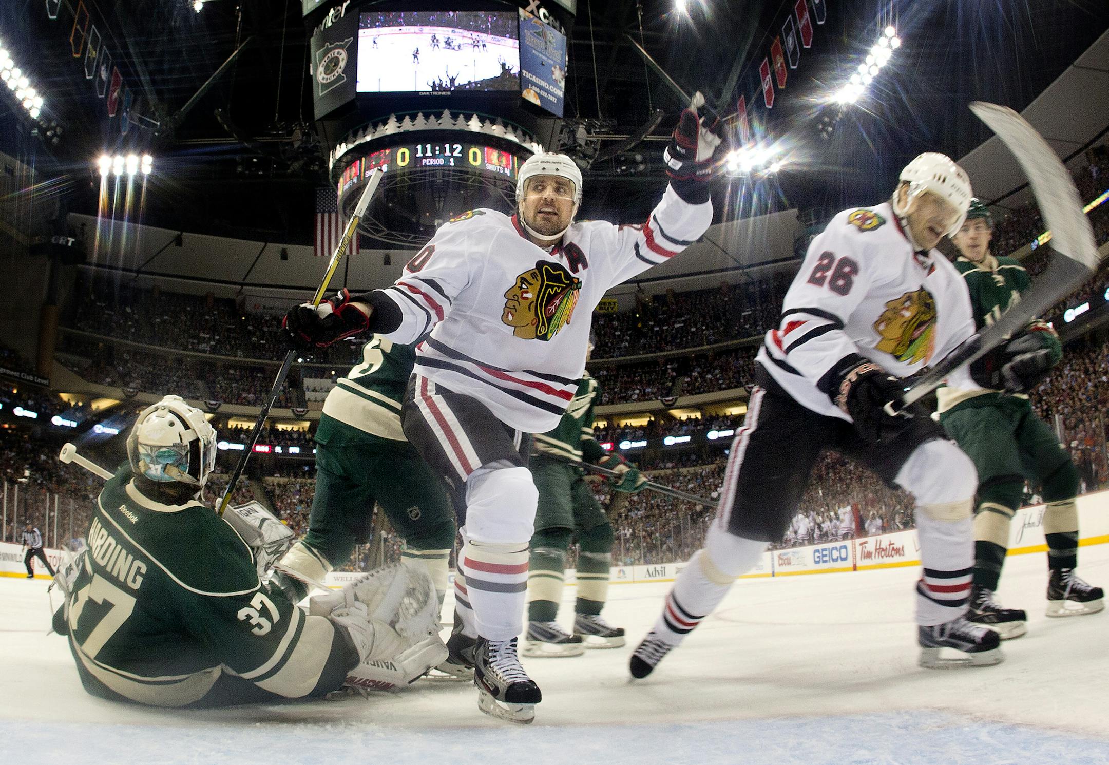 Chicago's Patrick Sharp celebrated with teammate Michal Handzus after he beat Wild goalie Josh Harding for a 1-0 Blackhawks lead during the 2013 NHL playoffs. Chicago won the series in five games.