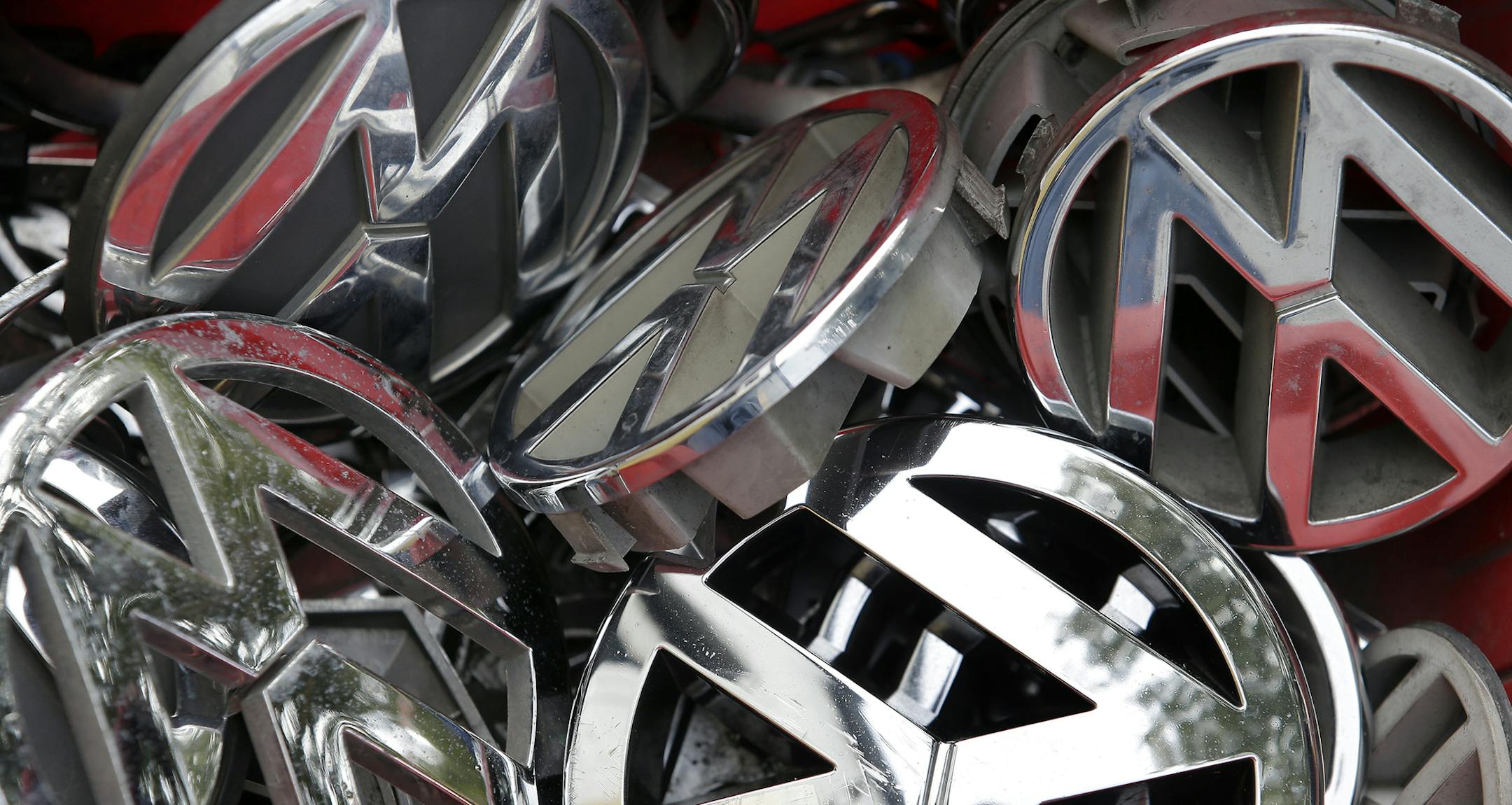 Volkswagen ornaments sit in a box in a scrap yard in Berlin, Germany.
