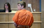 Levi Acre-Kendall looked back toward the court as he made his way out of the Polk County Justice Center courtroom, Wednesday, April 22, 2015 in Balsam
