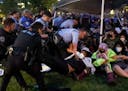 Police arrest pro-Palestinian protesters attempting to camp on Washington University's campus, Saturday, April 27, 2024, in St. Louis, Mo.