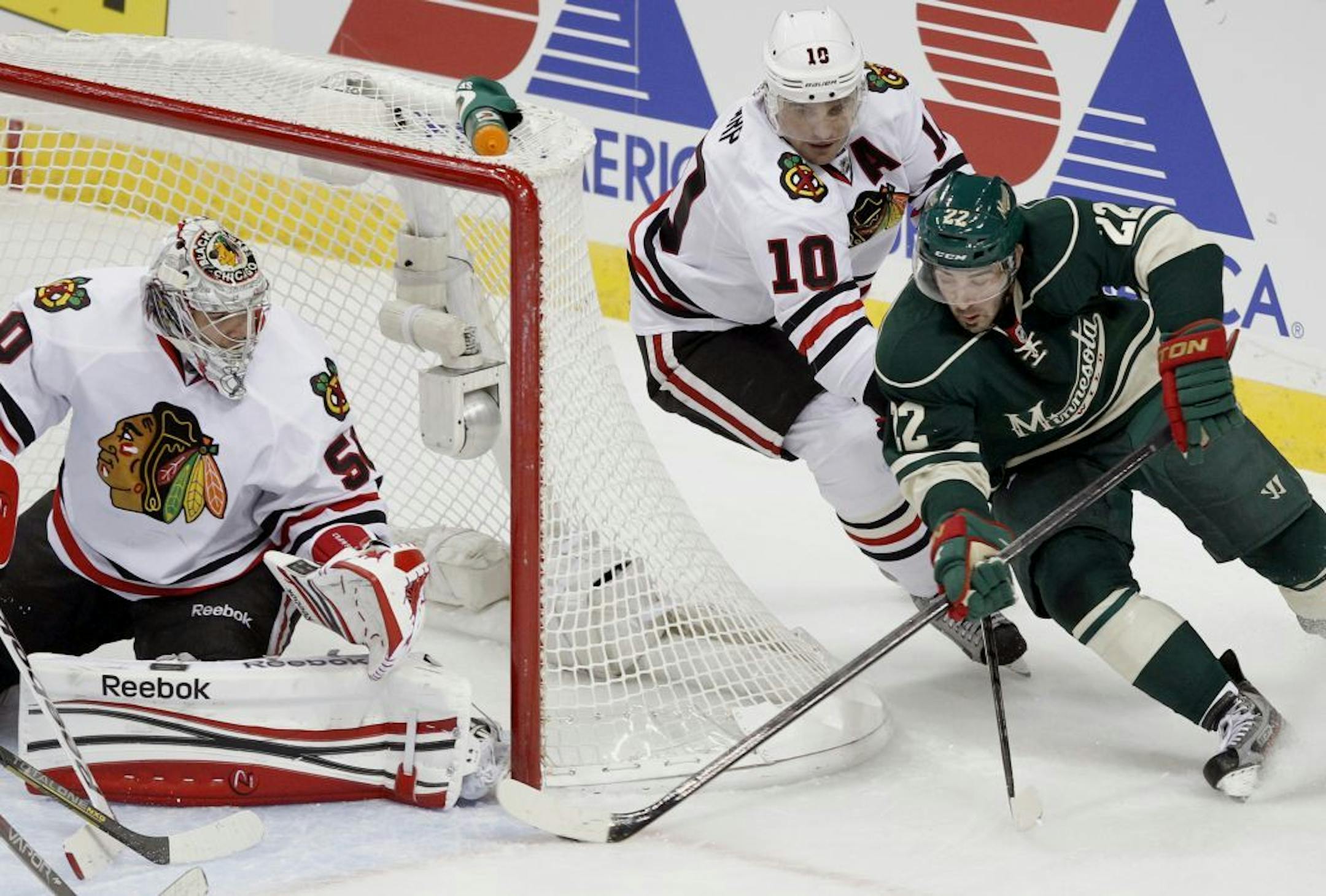 Minnesota Wild right wing Cal Clutterbuck attempts to score on Chicago Blackhawks goalie Corey Crawford.