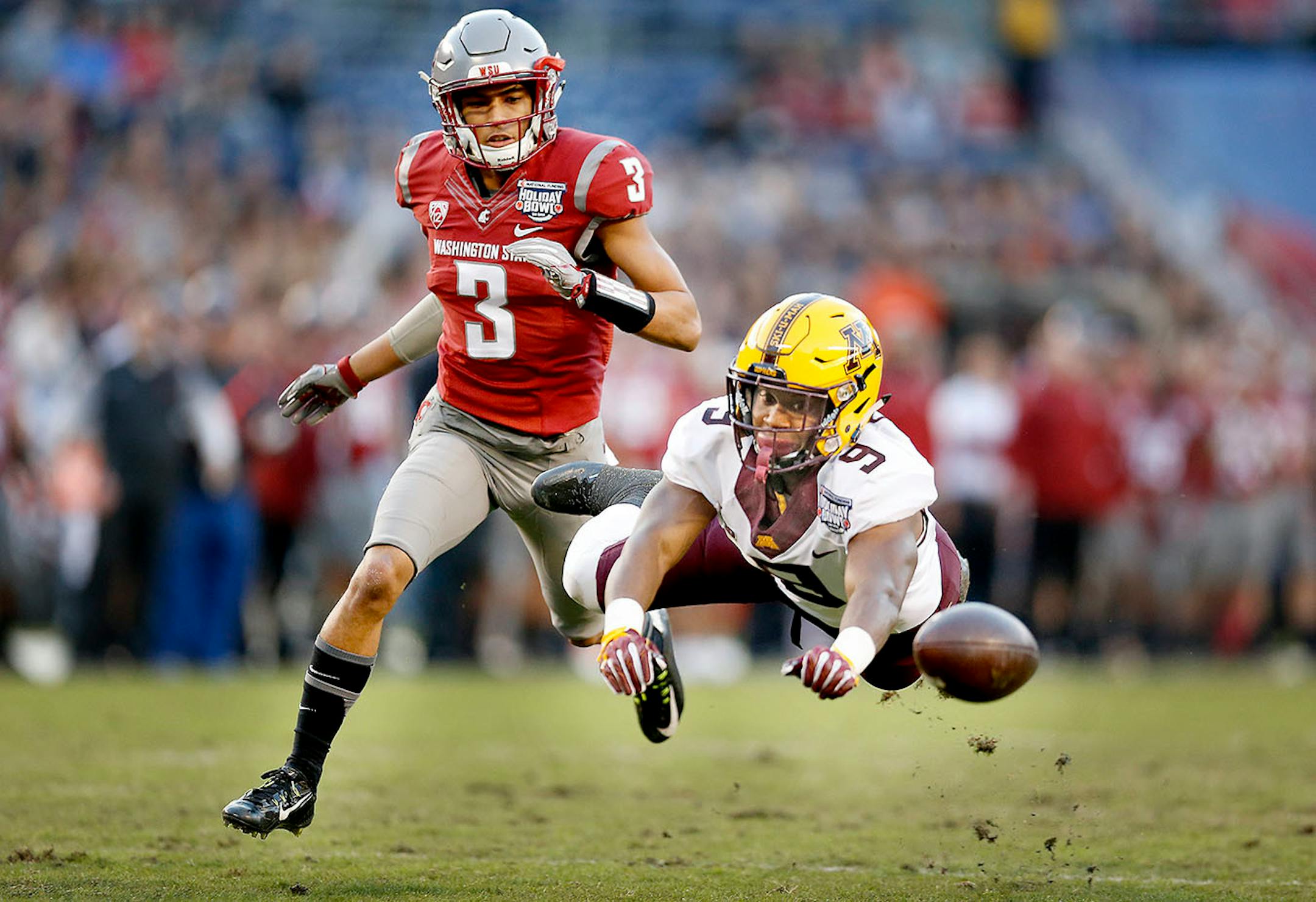 Minnesota's wide receiver Eric Carter missed a pass intended for him as he beat Washington State's cornerback Darrien Molton during the first quarter at Qualcomm Stadium for the San Diego Holiday Bowl, Tuesday, December 27, 2016 in San Diego, CA.