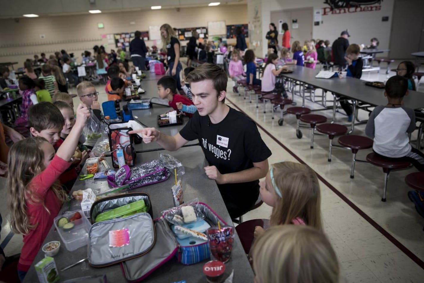 Alec Rohweder pointed out snap peas as he talked to a table of children about veggies during lunch at Oxbow Creek Elementary School on Tuesday, October 25, 2016, in Champlin, Minn.