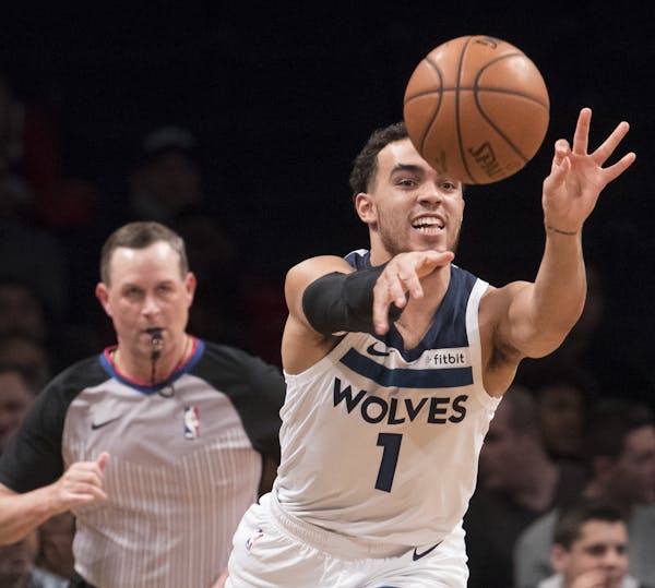 Minnesota Timberwolves guard Tyus Jones passes the ball during the first half of an NBA basketball game against the Brooklyn Nets, Friday, Nov. 23, 20