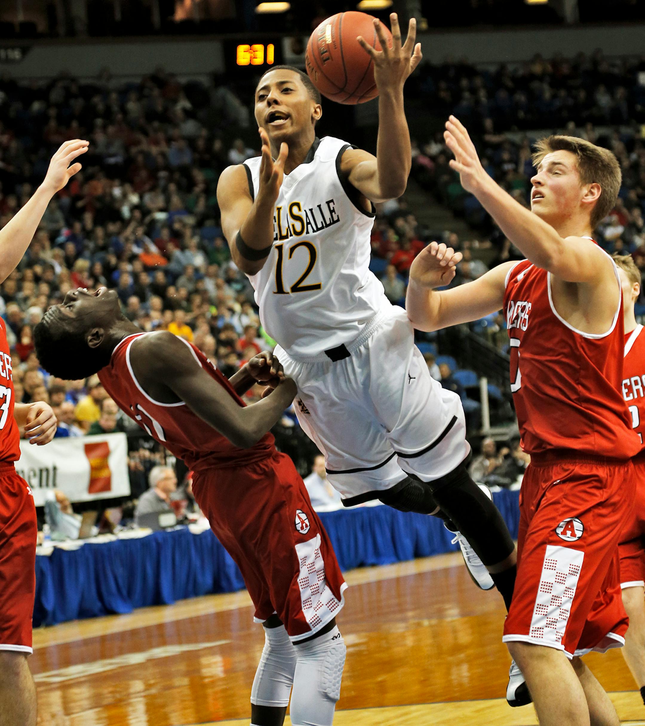 Islanders Jarvis Johnson (12) drove to the basket for a layup and was fouled in the process. ] Class 3A Boys State Basketball Tournament - DeLaSalle Islanders vs. Austin Packers. (MARLIN LEVISON/STARTRIBUNE(mlevison@startribune.com)