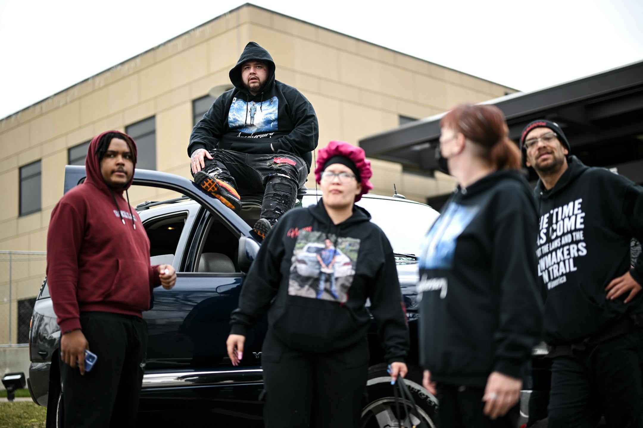 Family and friends of Katie Wright, including her son Damik Bryant, top, wait for the start of a press conference.