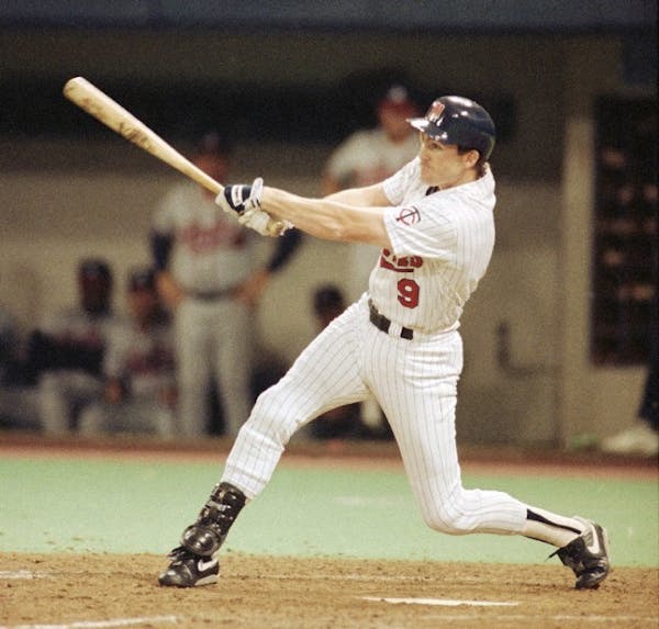 Gene Larkin follows through after hitting the game winning single to score Dan Gladden in the 10th inning of Game 7 of the 1991 World Series.