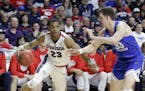 Gonzaga's Zach Norvell Jr. (23) drives covered by BYU's Dalton Nixon during the second half of the West Coast Conference tournament championship NCAA 