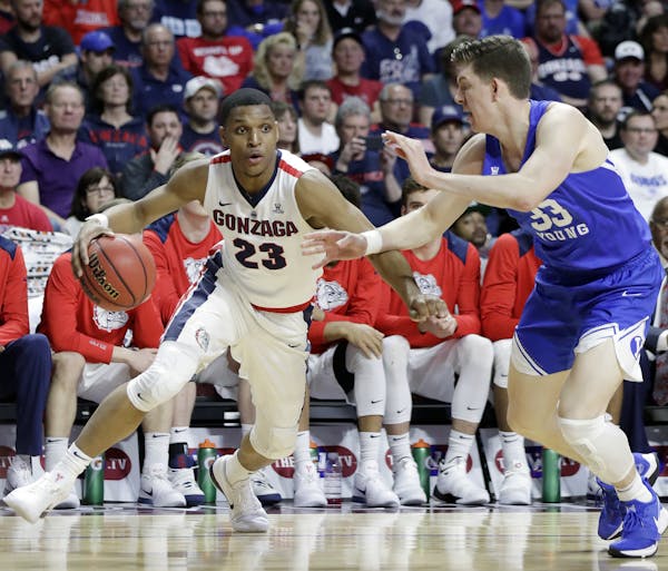 Gonzaga's Zach Norvell Jr. (23) drives covered by BYU's Dalton Nixon during the second half of the West Coast Conference tournament championship NCAA 