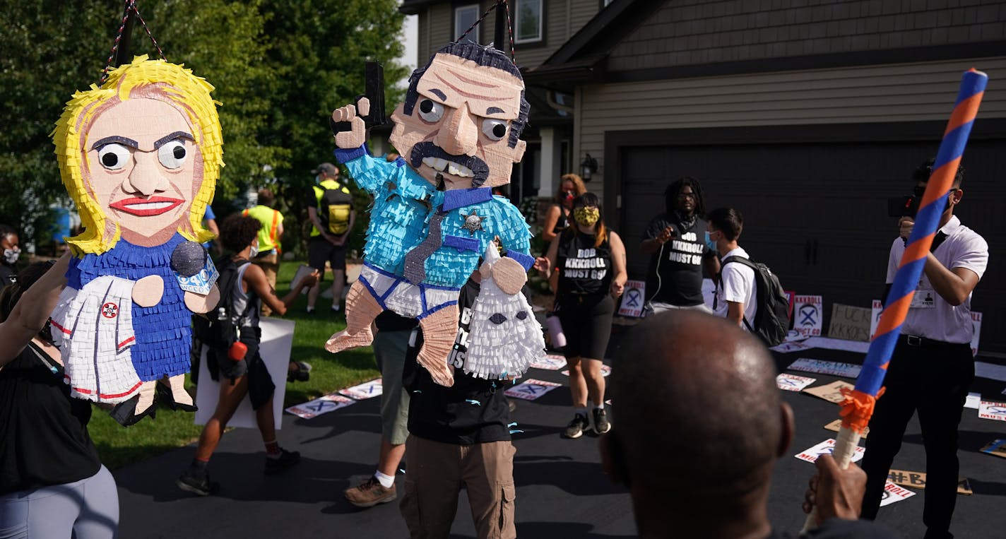 Protesters smashed piñata effigies of Minneapolis Police Federation president Bob Kroll and his wife WCCO reporter Liz Collins made by Mathew Foster of Minneapolis held as they and a group of more than 100 Black Lives Matter protesters rallied outside Kroll's home in a continued effort to get he and his wife fired from their jobs Saturday. ] ANTHONY SOUFFLE • anthony.souffle@startribune.com More than 100 Black Lives Matter protesters gathered outside Minneapolis Police Federation president Bob K