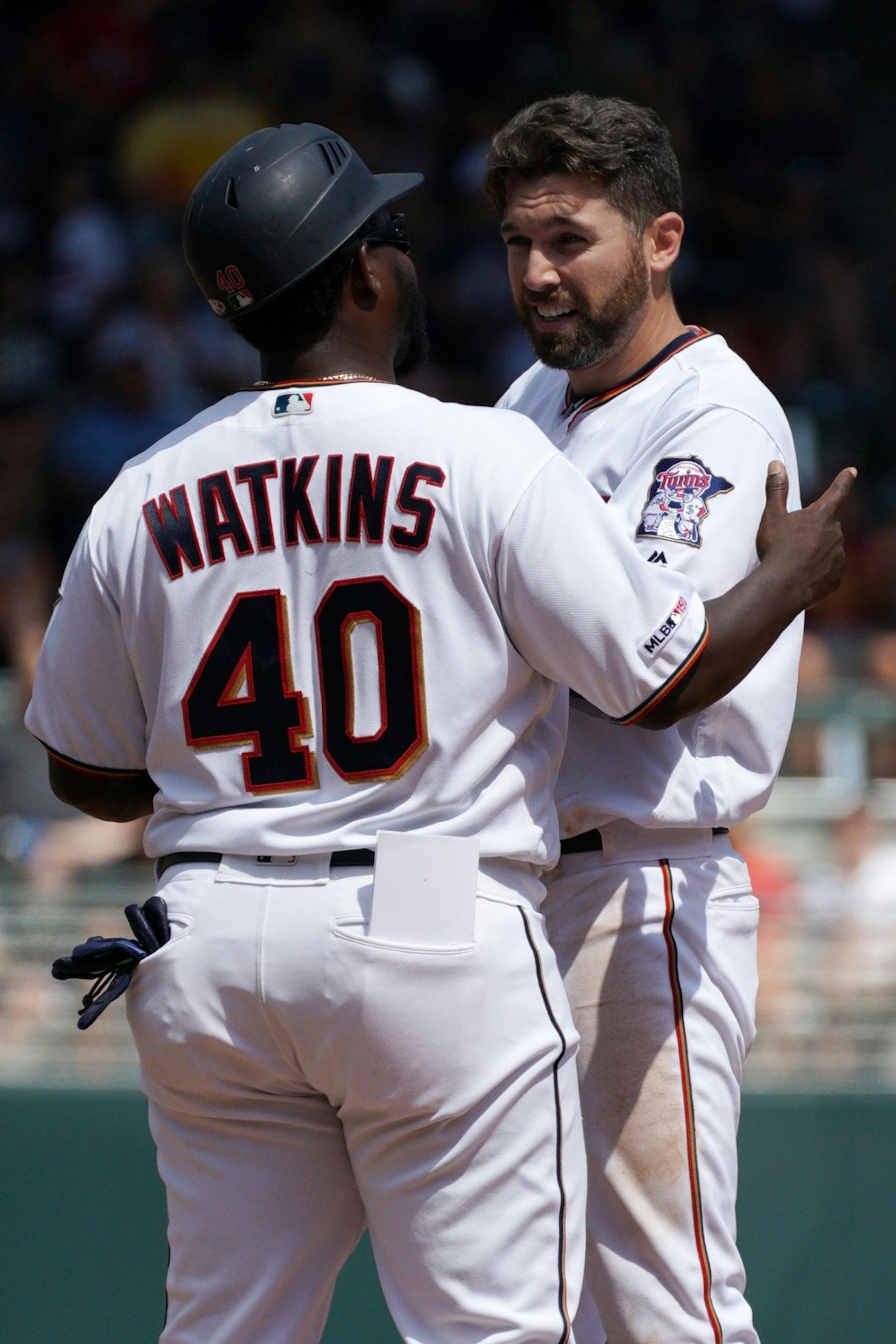 Minnesota Twins center fielder Jake Cave (60) was congratulated by Minnesota Twins first base coach Tommy Watkins (40) at second base after he a double in the fifth inning.