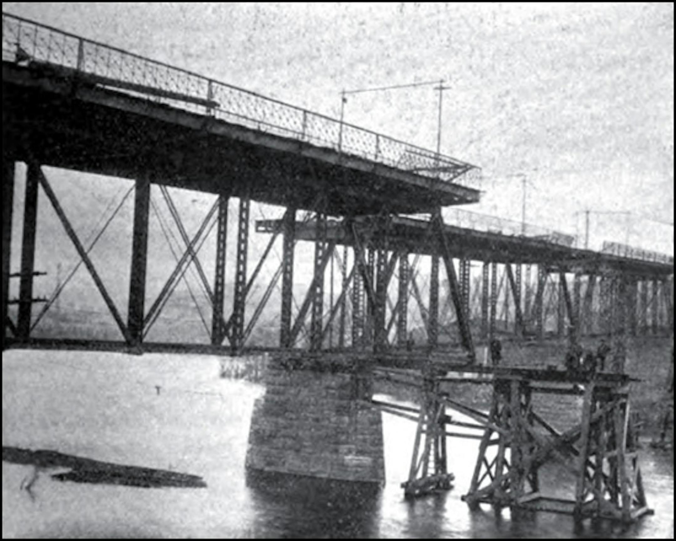 Public domain image from January 1900 issue of the Journal of the Association of Engineering Societies shows a 120-ton section of St. Paul's Wabasha Street bridge being maneuvered into place.