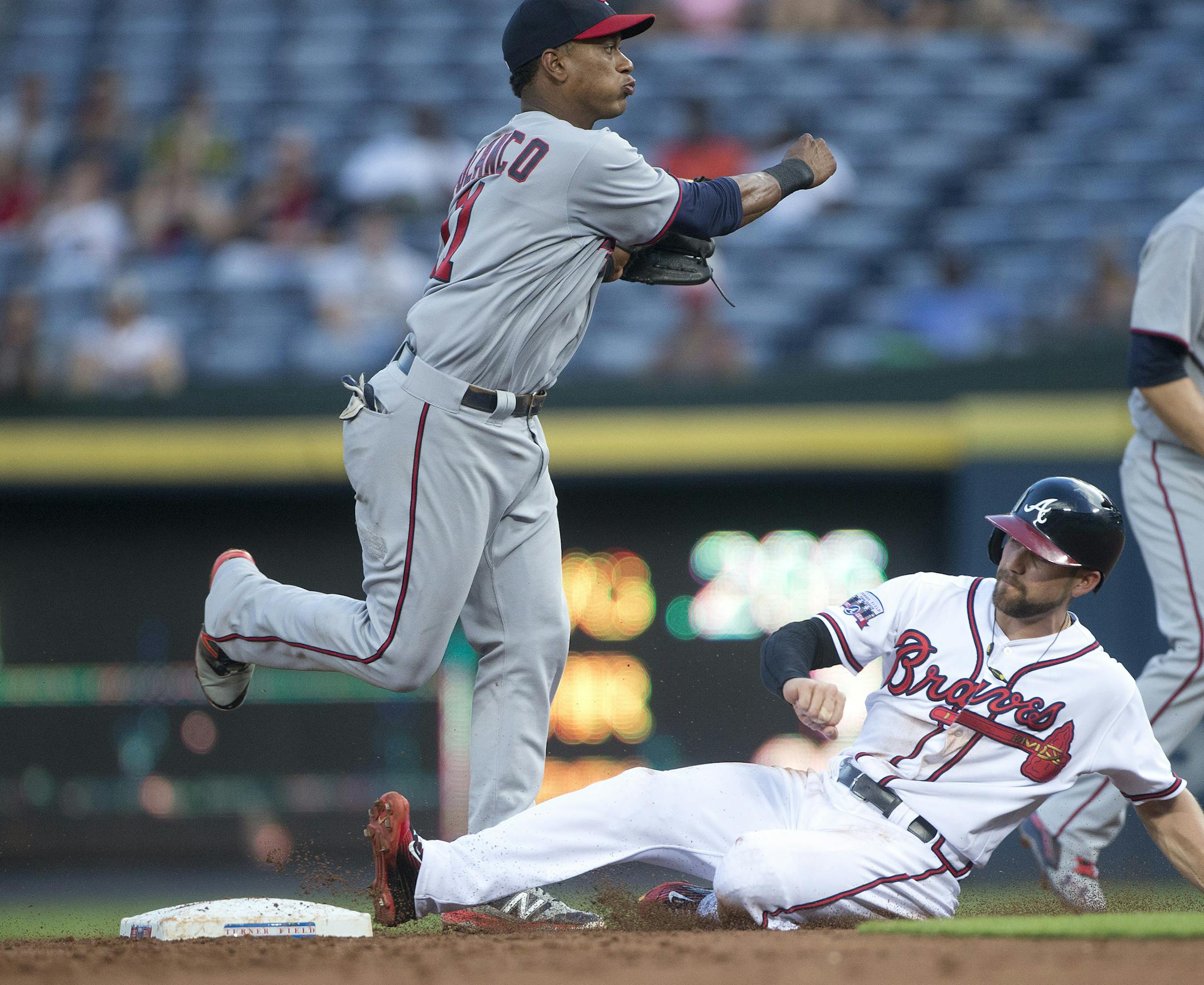 Minnesota Twins third baseman Jorge Polanco (11) forces out Atlanta Braves' Ender Inciarte as he turns a double play on an Adonis Garcia ground ball in the first inning of a baseball game in Atlanta, Wednesday, Aug. 17, 2016. (AP Photo/John Bazemore)