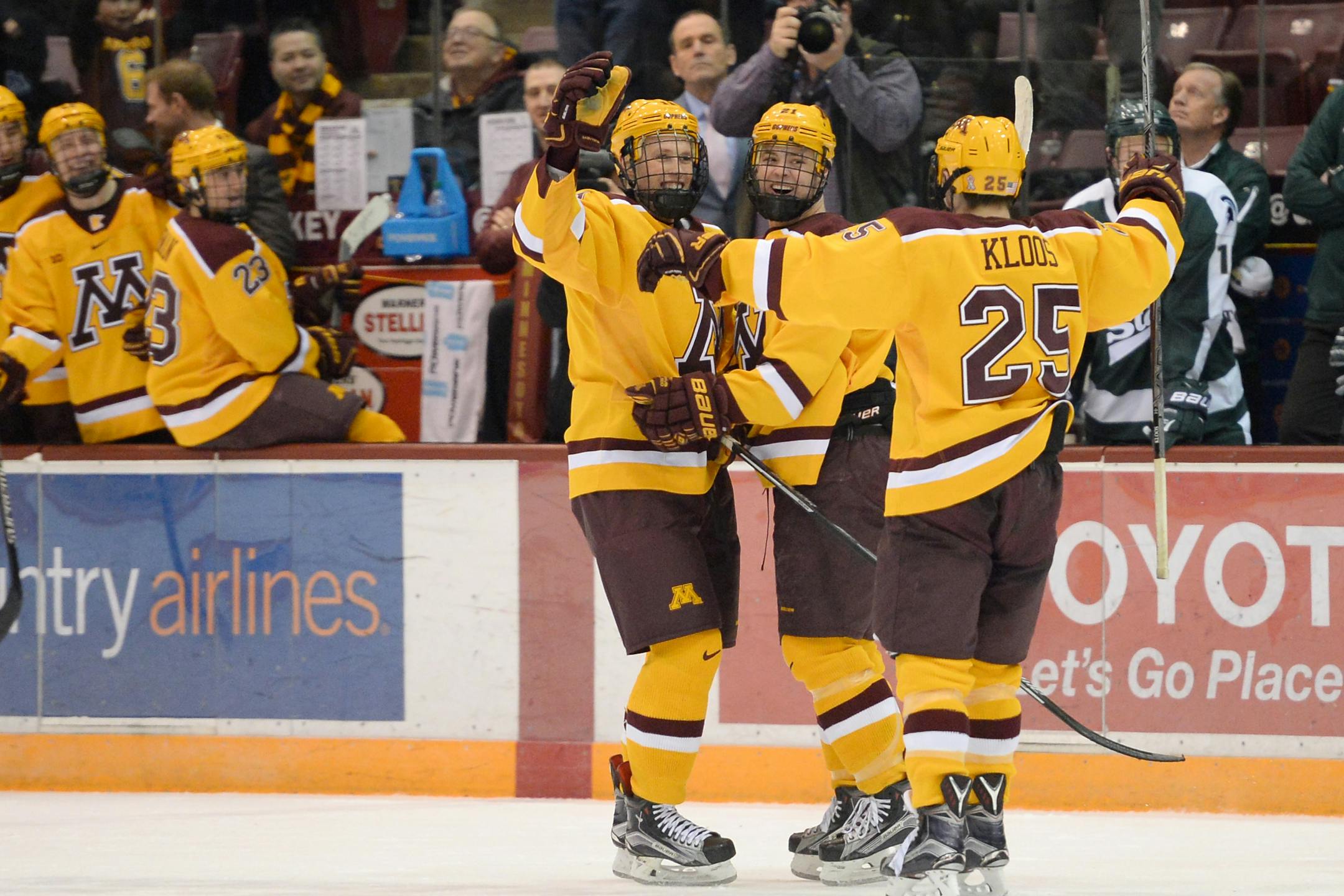 FILE - Minnesota Gophers defenseman Nick Seeler (11), left wing Connor Reilly (21) and center Justin Kloos (25) celebrated earlier this season.