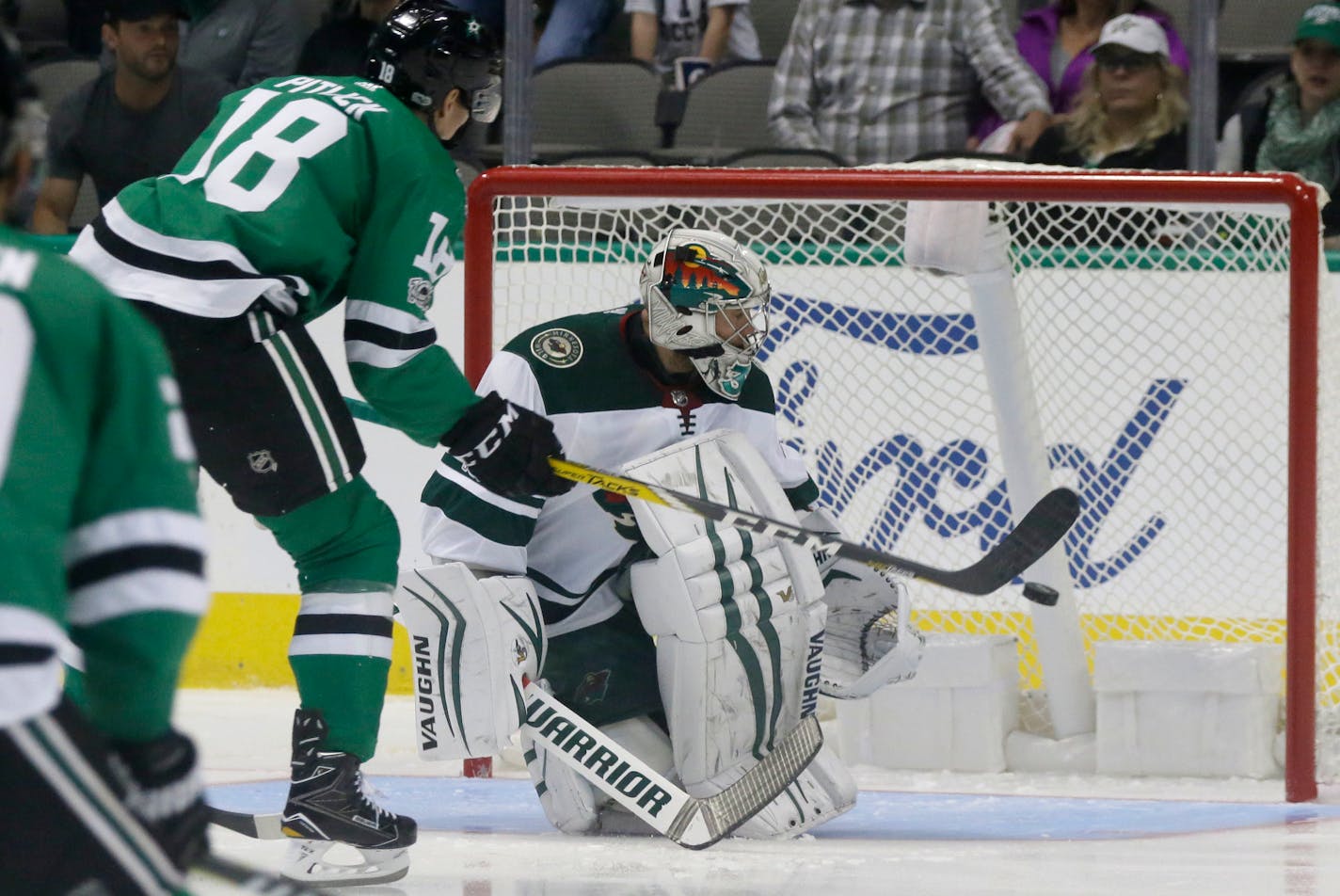 Dallas Stars right wing Tyler Pitlick (18) scores a goal against Minnesota Wild goalie Alex Stalock during the first period of a preseason NHL hockey game in Dallas, Tuesday, Sept. 26, 2017. (AP Photo/LM Otero)