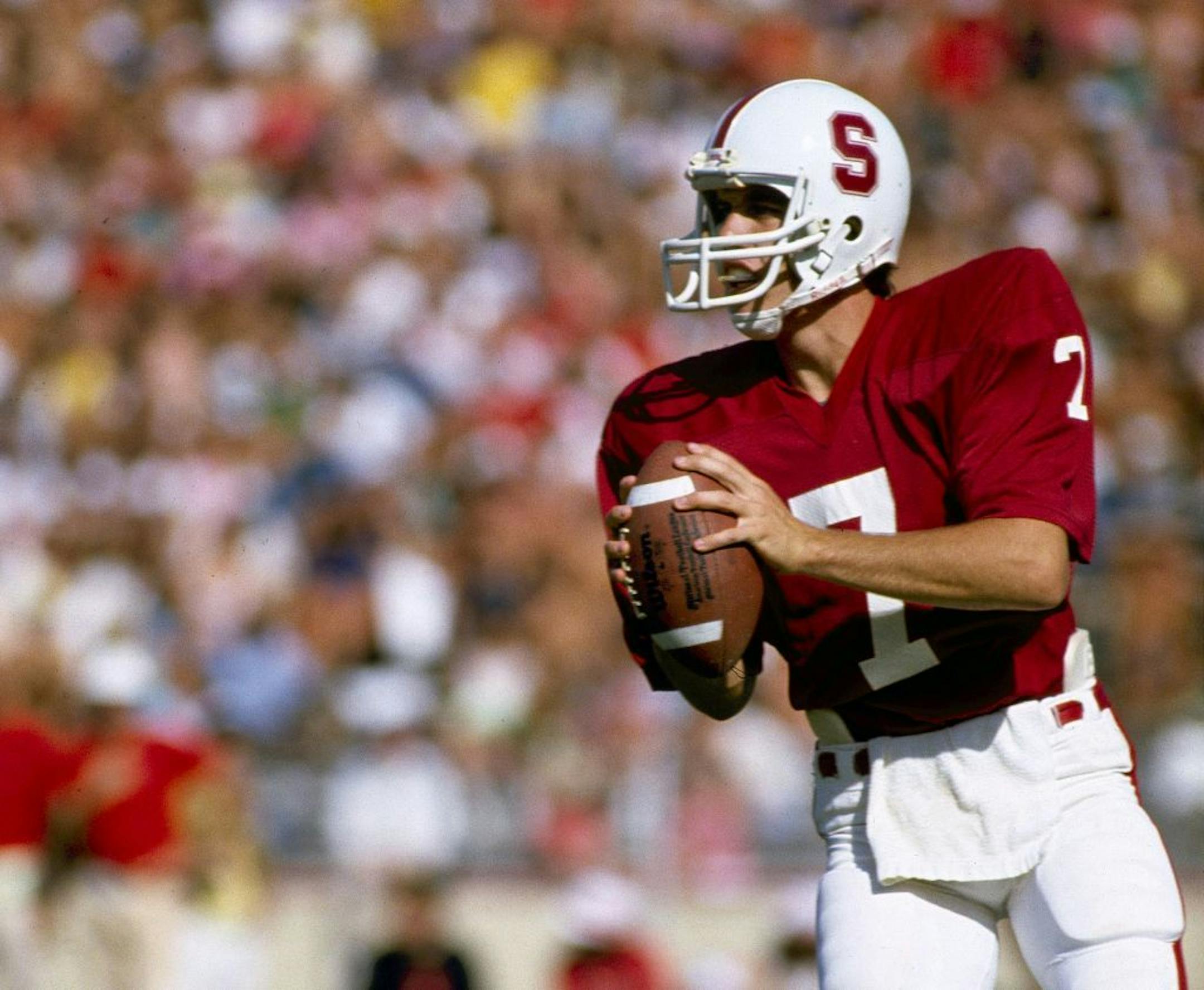 FILE - In this Oct. 1982, file photo, Stanford University quarterback John Elway looks to pass during an NCAA college football game in Palo Alto, Calif. The former Cardinal quarterback and No. 1 overall pick of the 1983 NFL draft will have his jersey retired during halftime of Stanford's home game against Oregon on Nov. 7.