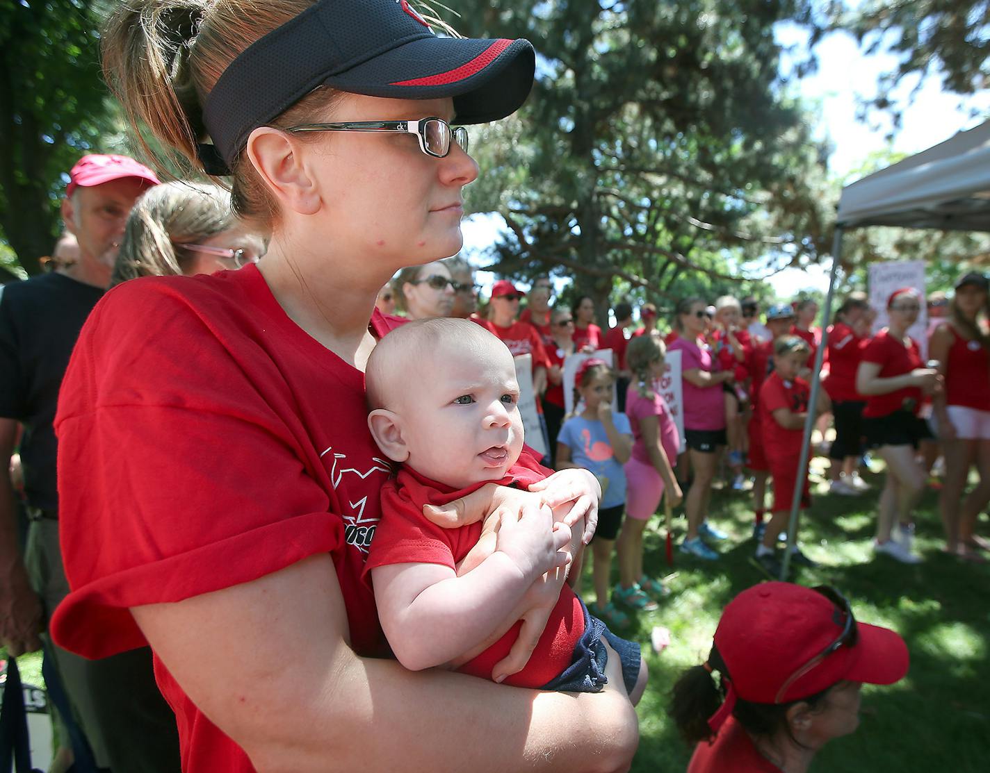 Melisa Anderson, cq, and her 4-month-old son Lucas listened to a press conference by the Members of the Minnesota Nurses Association outside Abbott Northwestern Hospital as they continued their strike, Monday, June 20, 2016 in Minneapolis, MN. Anderson is a nurse at the Mother/Baby Center at Abbott Northwestern. ] (ELIZABETH FLORES/STAR TRIBUNE) ELIZABETH FLORES &#x2022; eflores@startribune.com