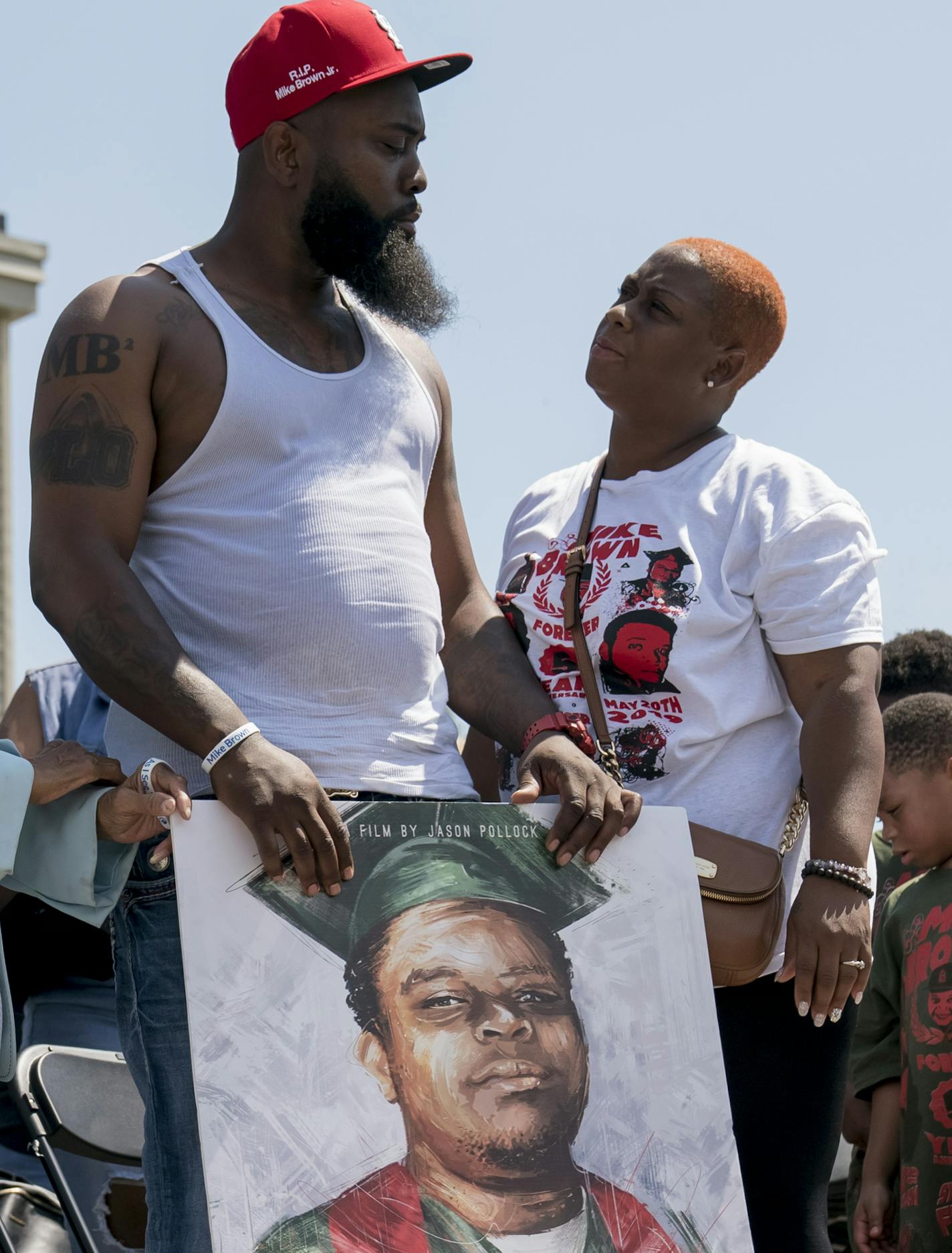 Michael Brown Sr., right, and his wife, Cal Brown, during a moment of silence at a memorial for Brown's son, Michael Brown Jr., on the five-year anniversary of his death, in Ferguson, Mo., Aug. 9, 2019. Five years to the day after a police officer fatally shot Michael Brown Jr., his father called for a new investigation into his death. (Whitney Curtis/The New York Times)