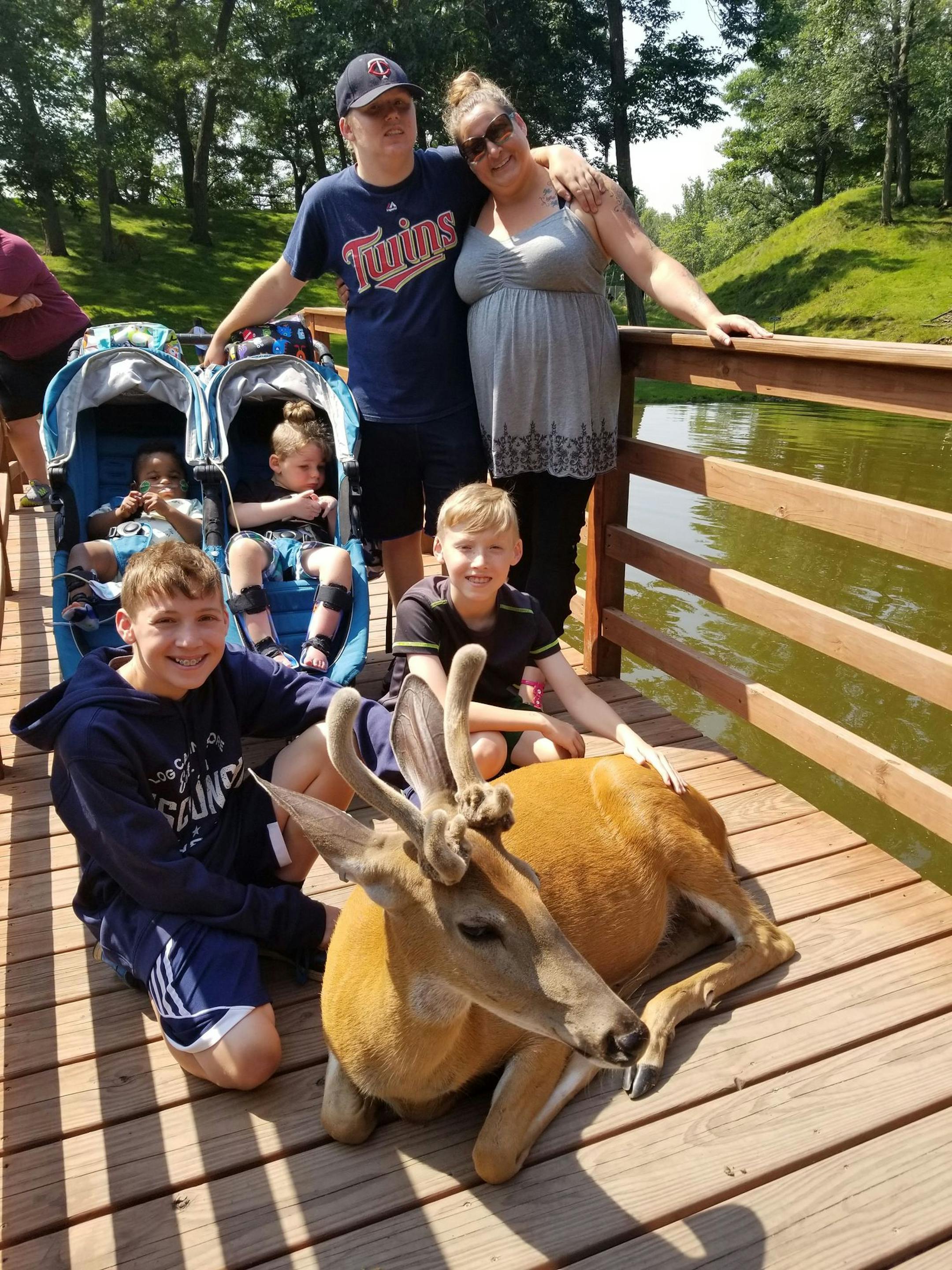 Carrie Edberg, pictured here with her five boys, is battling a $15,000 sinkhole in her front yard.