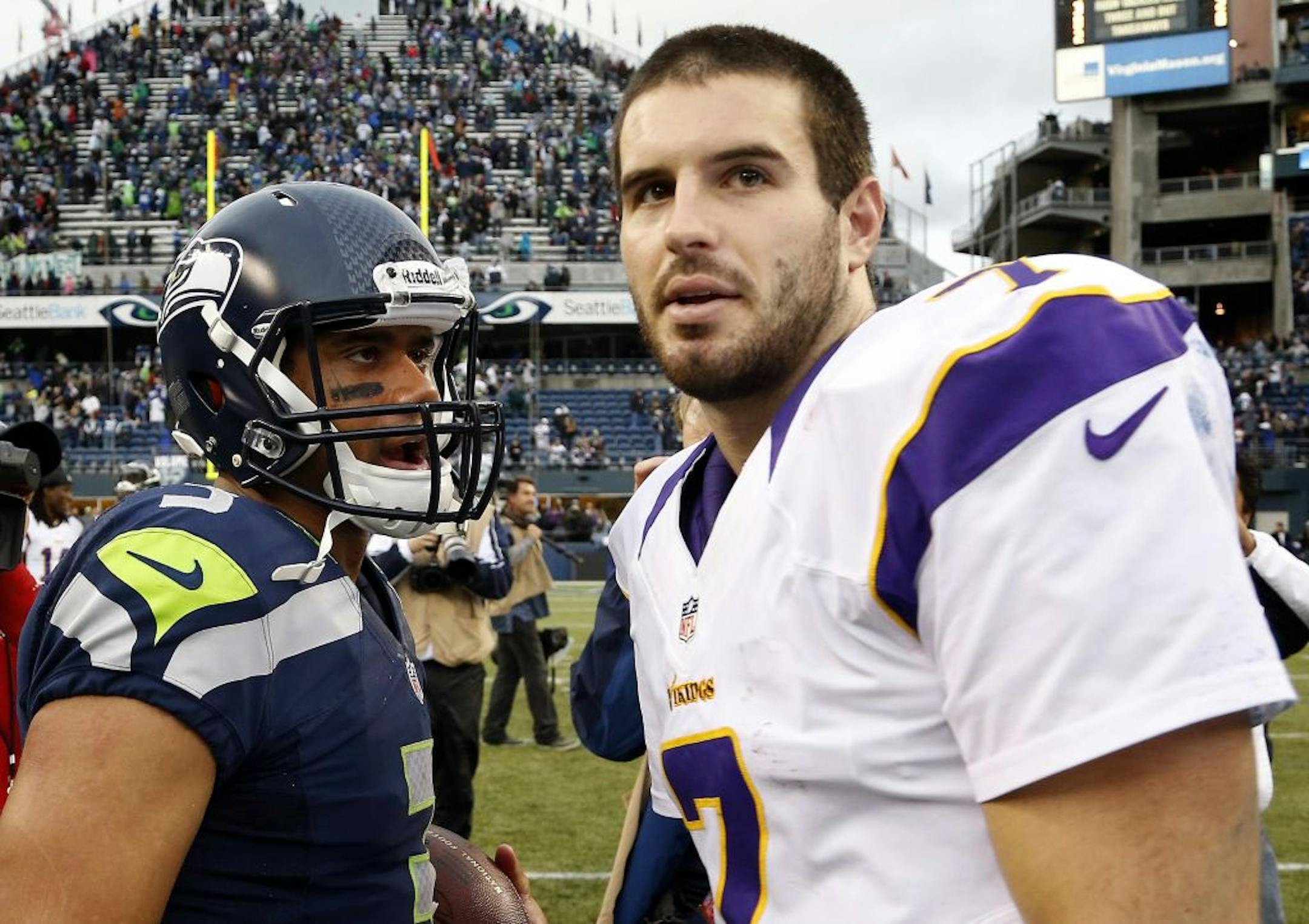 Seattle quarterback Russell Wilson (3) and Minnesota Vikings quarterback Christian Ponder (7).