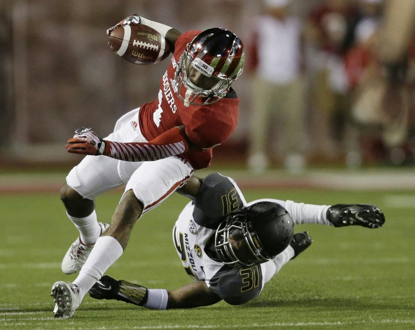 Indiana's Shane Wynn (1) is tackled by Missouri's E.J. Gaines (31) during the first half of an NCAA college football game Saturday, Sept. 21, 2013, in Bloomington, Ind.