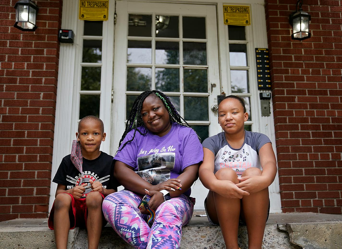 Spencer-Hartwig recently applied for state rental assistance and been accepted but has yet to receive any payments. "I'd be homeless," she said, without any assistance. Spencer-Hartwig was photographed with her children Ka'Marria Spencer-Morgan, 13, right, and Kavion Rodgers, 6, left, outside their apartment building. DAVID JOLES • david.joles@startribune.com