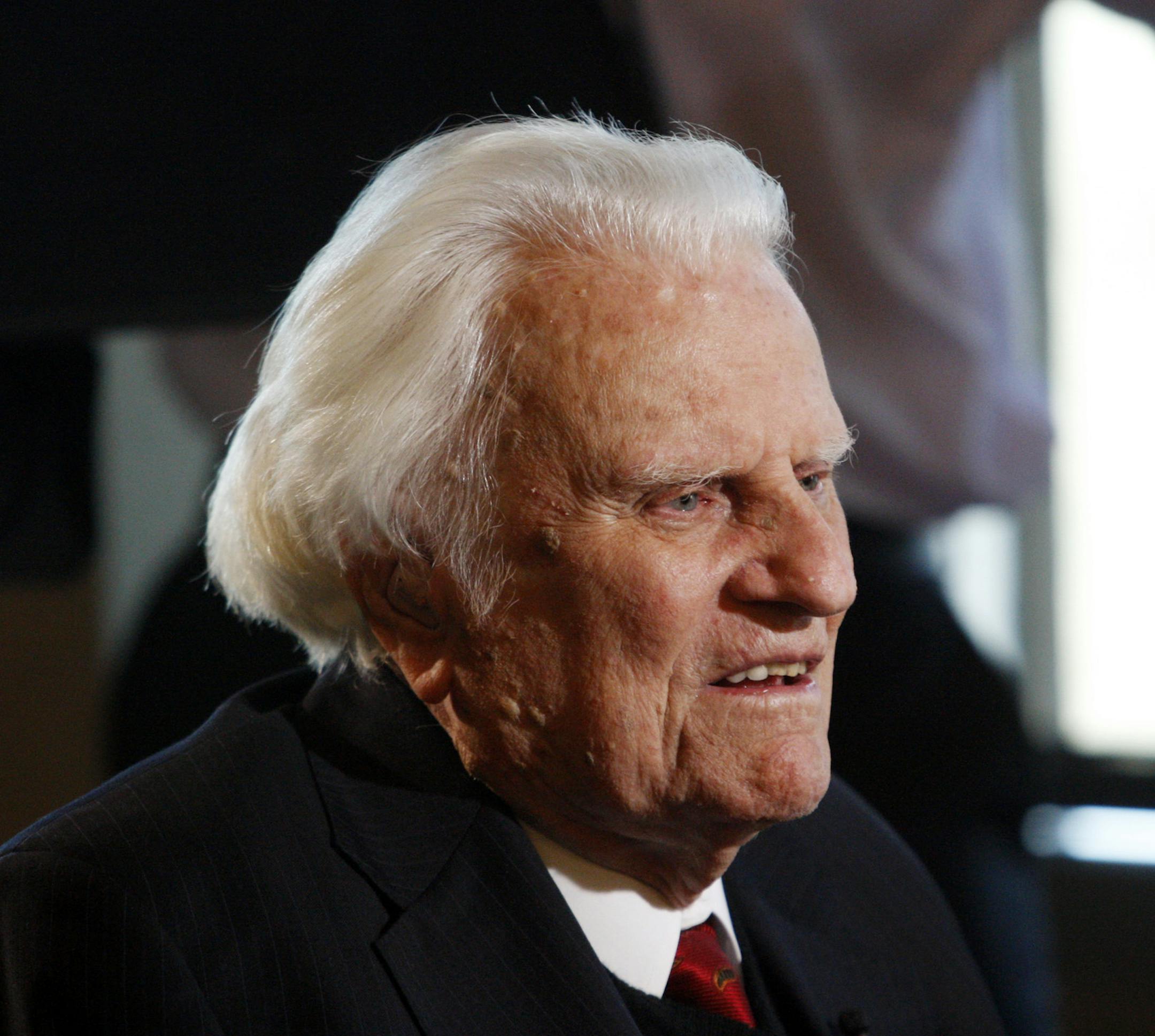 FILE - In this Dec. 20, 2010, file photo, Rev. Billy Graham is interviewed at the Billy Graham Evangelistic Association headquarters in Charlotte, N.C. Graham plans to celebrate his 96th birthday, on Friday, Nov. 7, 2014, with family and friends. Last year, 900 people attended a two-hour party for Graham at an Asheville hotel. His son, the Rev. Franklin Graham, said Wednesday that his father is in good spirits, he's eating well, and his mind is still sharp. (AP Photo/Nell Redmond, File)