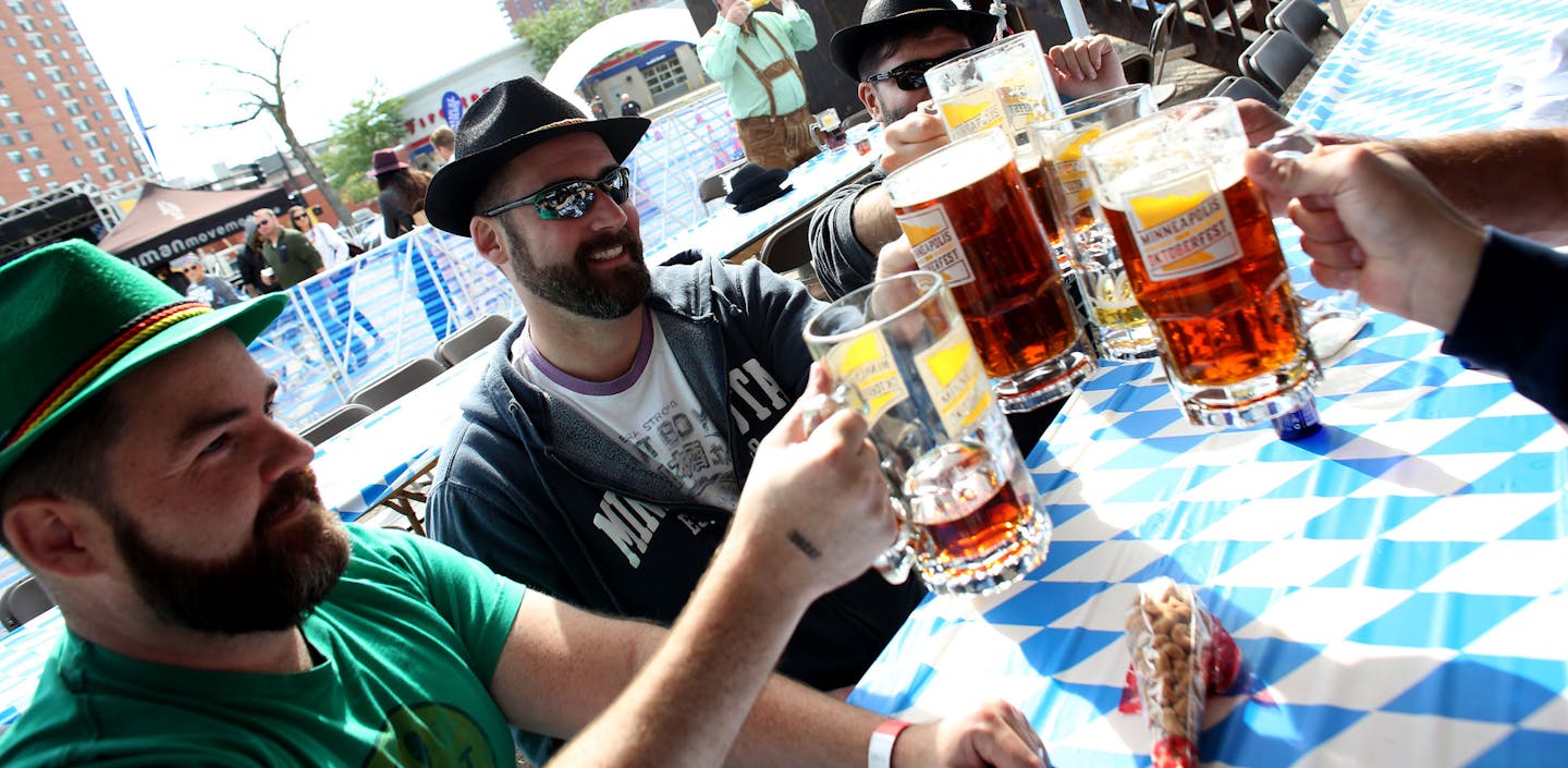 Mark Godwin, Ryan Whisenant and their friends toast each other in the VIP tent. ] (KYNDELL HARKNESS/STAR TRIBUNE) kyndell.harkness@startribune.com Octoberfest in Minneapolis Min., Saturday, September 13, 2014.