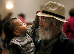 Herb Zimmermann held is newly adopted granddaughter 16-month old Rylan during the 16th annual Celebrate Adoption event held by the Minnesota Departmen