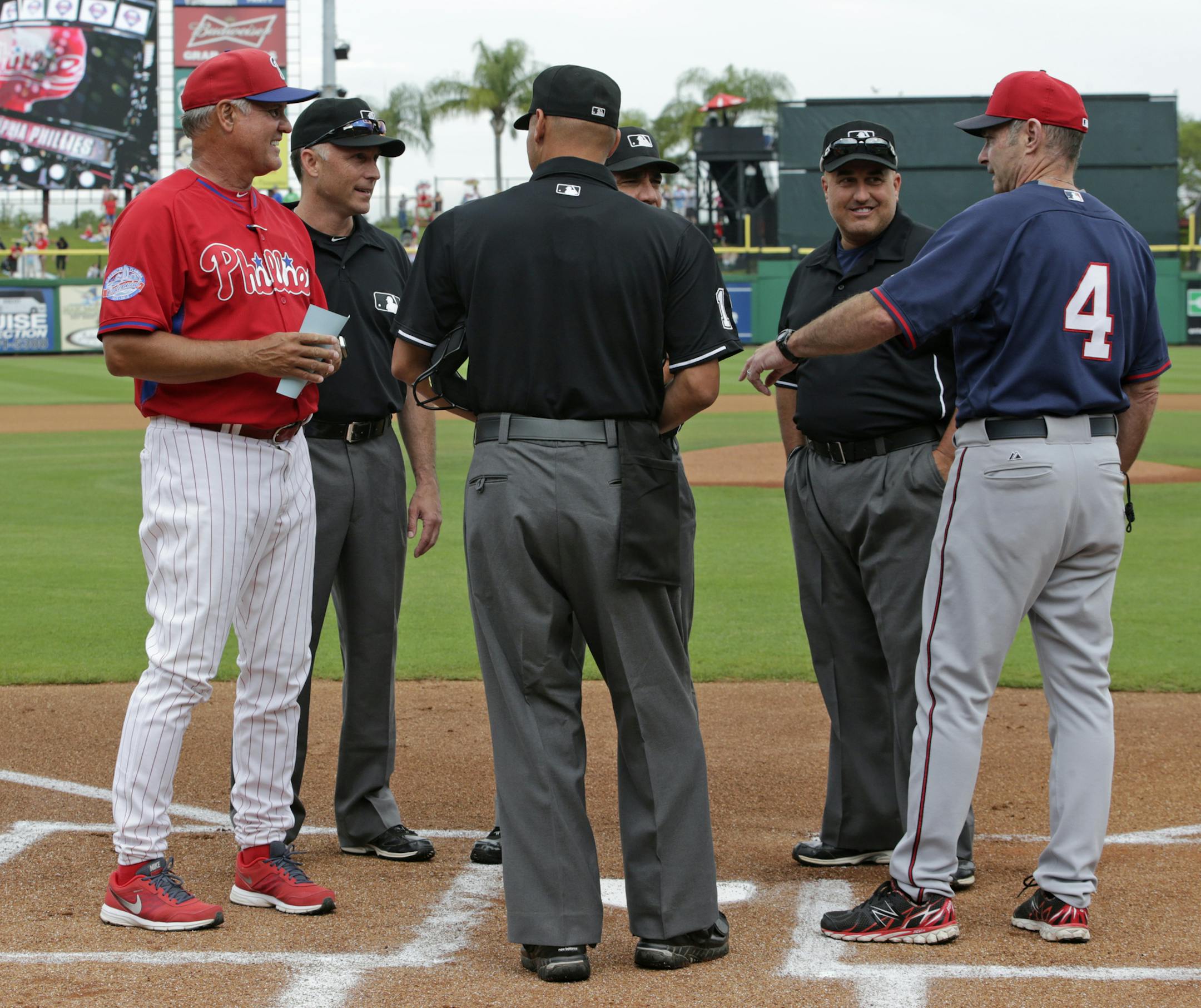 Philadelphia Phillies manager Ryne Sandberg, left, a 2005 Hall of Fame inductee, and Minnesota Twins manager Paul Molitor, (4), a 2004 Hall of Fame inductee, talk after presenting their lineups to the umpires before a spring training baseball game between the Phillies and the Twins in Clearwater, Fla., Monday, March 23, 2015. It is the first time in Major League Baseball history two current Hall of Famers have managed a game against each other. (AP Photo/Kathy Willens)