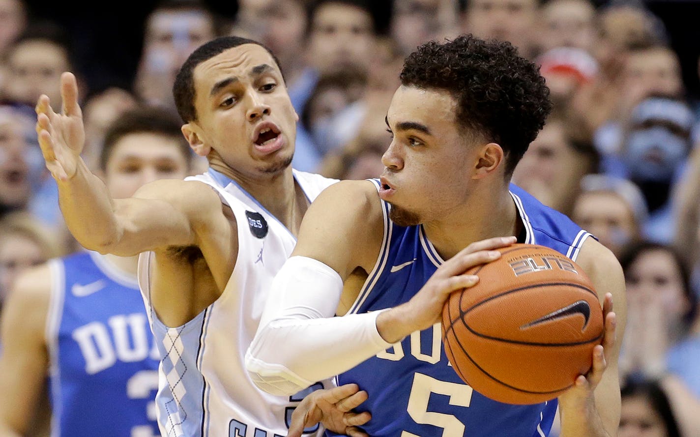 North Carolina's Marcus Paige, left, guards Duke's Tyus Jones (5) during the first half of an NCAA college basketball game Saturday, March 7, 2015 in Chapel Hill, N.C. (AP Photo/Gerry Broome)