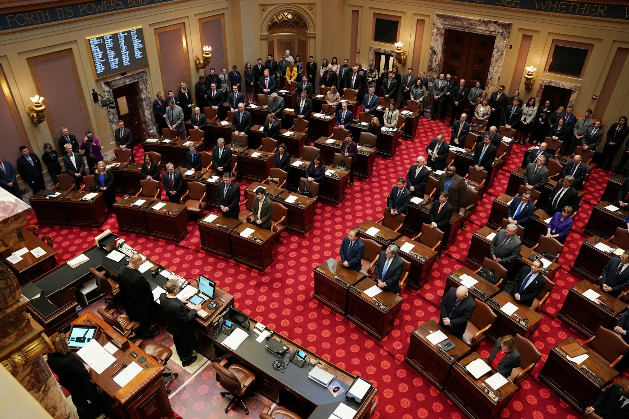 Lawmakers stood in the Senate Chamber for the first day of the legislative session.