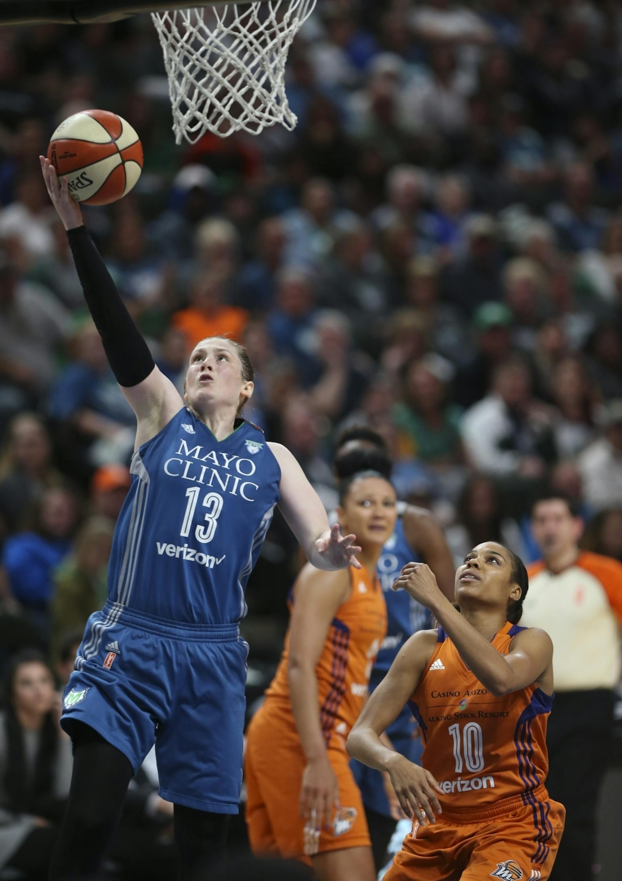 Minnesota Lynx guard Lindsay Whalen (13) put up a third quarter shot while Phoenix Mercury guard Lindsey Harding (10) watched.