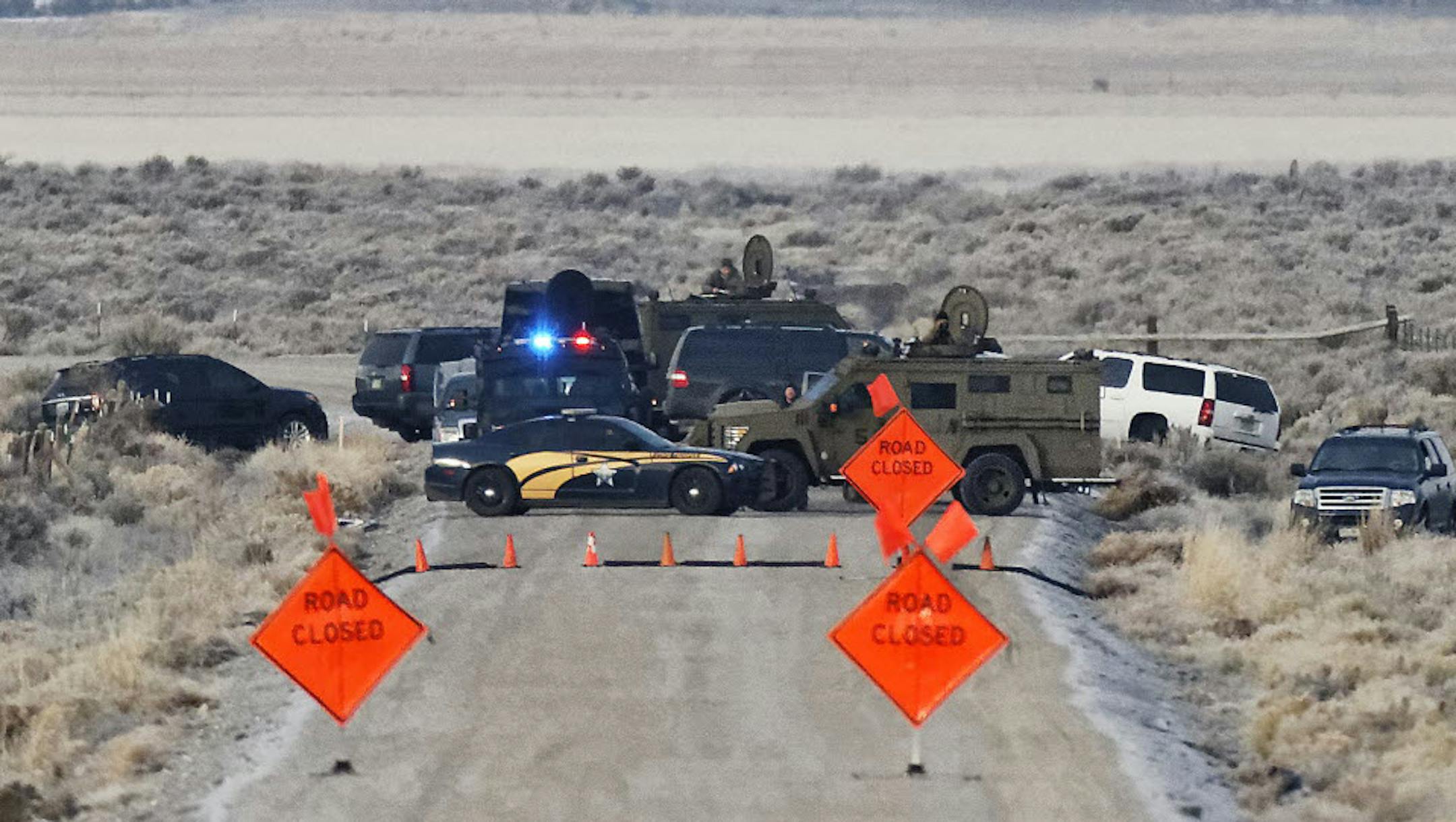Law enforcement personnel block an access road to the Malheur National Wildlife Refuge, Wednesday, Jan. 27, 2016, near Burns, Ore. Authorities were restricting access on Wednesday to the Oregon refuge being occupied by an armed group.