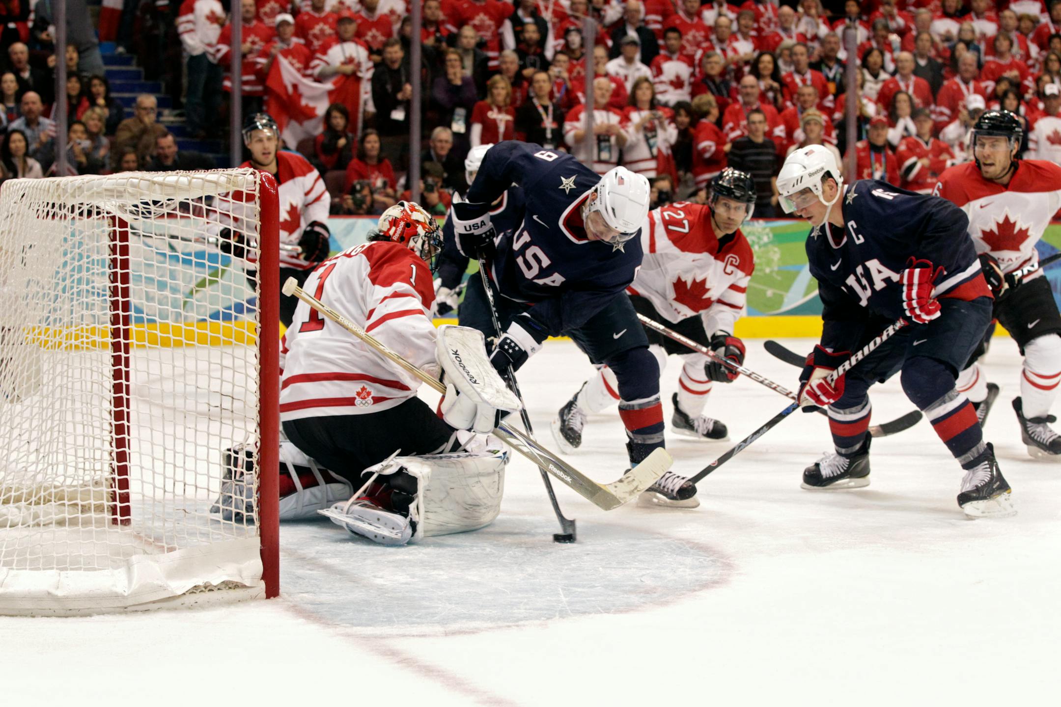 FILE -- U.S. mens hockey forward Zach Parise (9), center, about to score with 24 seconds left in regulation against Canada's goalie Roberto Luongo (1) to tie their gold medal game, which Canada went on to win in overtime, during the 2010 Winter Olympics in Vancouver, Canada, Feb. 28, 2010. The American men, who face Canada in a semifinal match Friday, Feb. 21 at the 2014 Sochi Winter Olympics, have waited four years for a chance to unseat their North American rival. (Chang W. Lee/The New York Ti