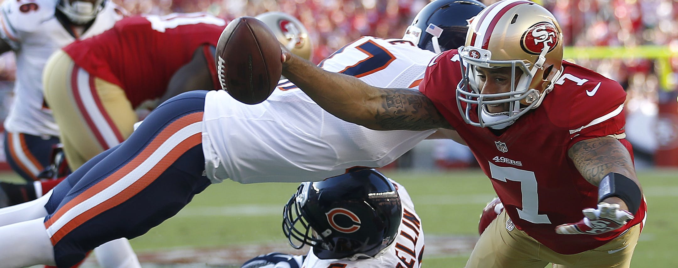 San Francisco 49ers quarterback Colin Kaepernick (7) is pushed out of bounds by Chicago Bears free safety Chris Conte, top, as Shea McClellin helps on defense during the first quarter of an NFL football game in Santa Clara, Calif., Sunday, Sept. 14, 2014. (AP Photo/Tony Avelar) ORG XMIT: FXN104